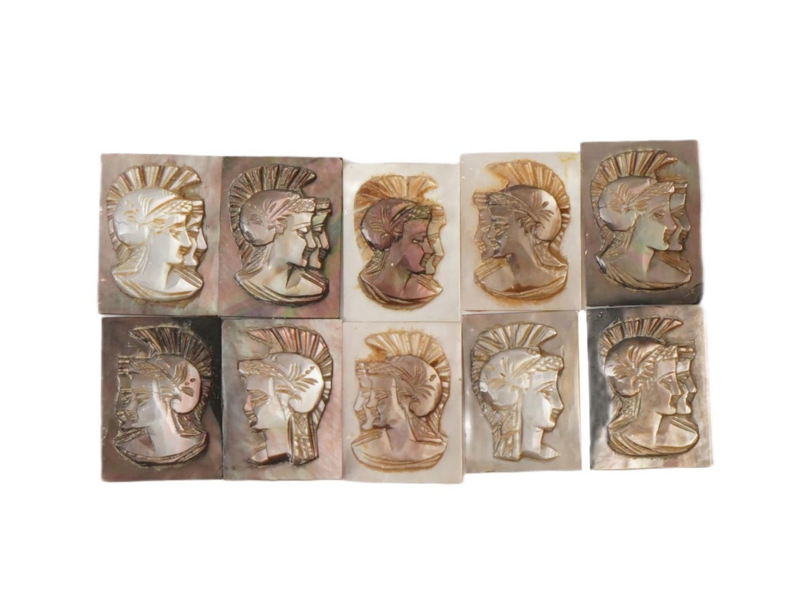 ANTIQUE VINTAGE GRECO ROMAN PROFILE CARVED SHELL CAMEOS: A set of ten antique or vintage carved shell cameos, each depicting the head profile of a Greco-Roman figure wearing a crested helmet. Carved from a mother of pearl or abalone shell, the pieces displa