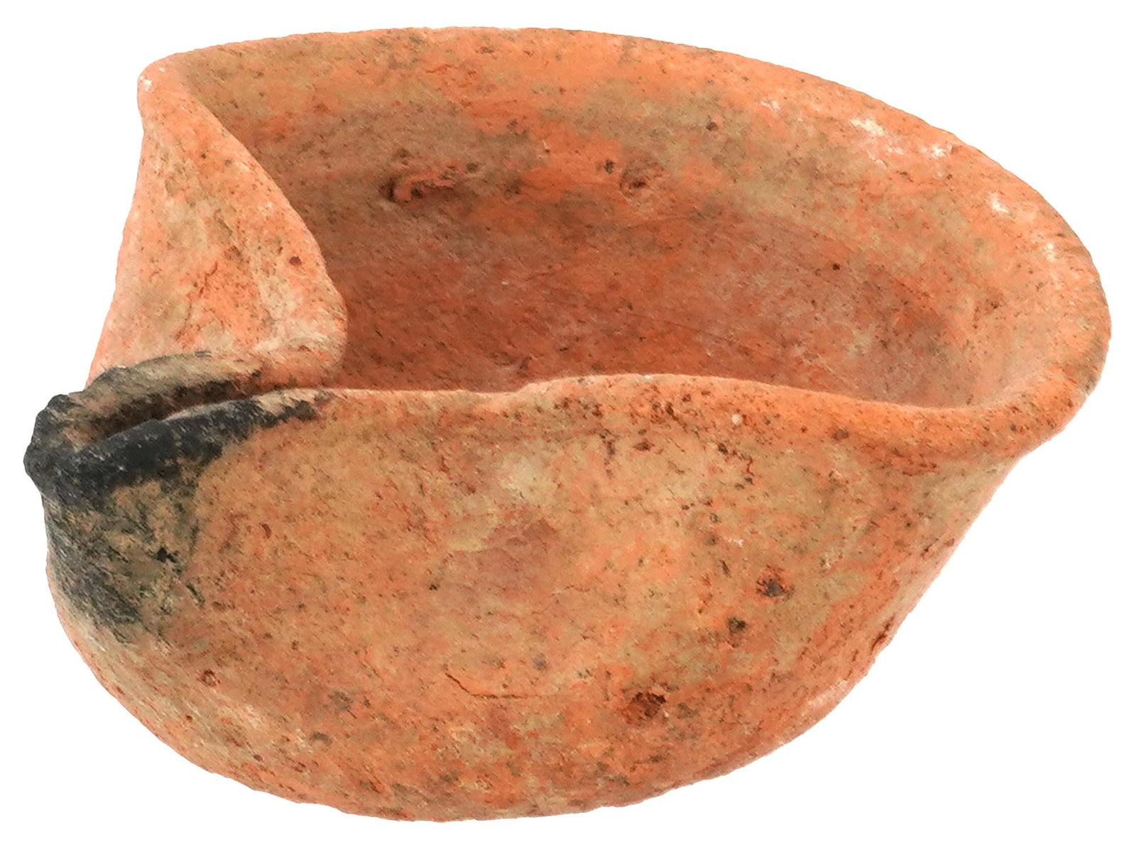 ANCIENT PHOENICIAN TERRACOTTA OIL LAMP 800 TO 600 BC: An ancient Phoenician terracotta oil lamp dating from 800 to 600 BC. It features a simple, rounded bowl shape with a pronounced duck spout for the wick. The terracotta has a reddish orange hue. Ancien