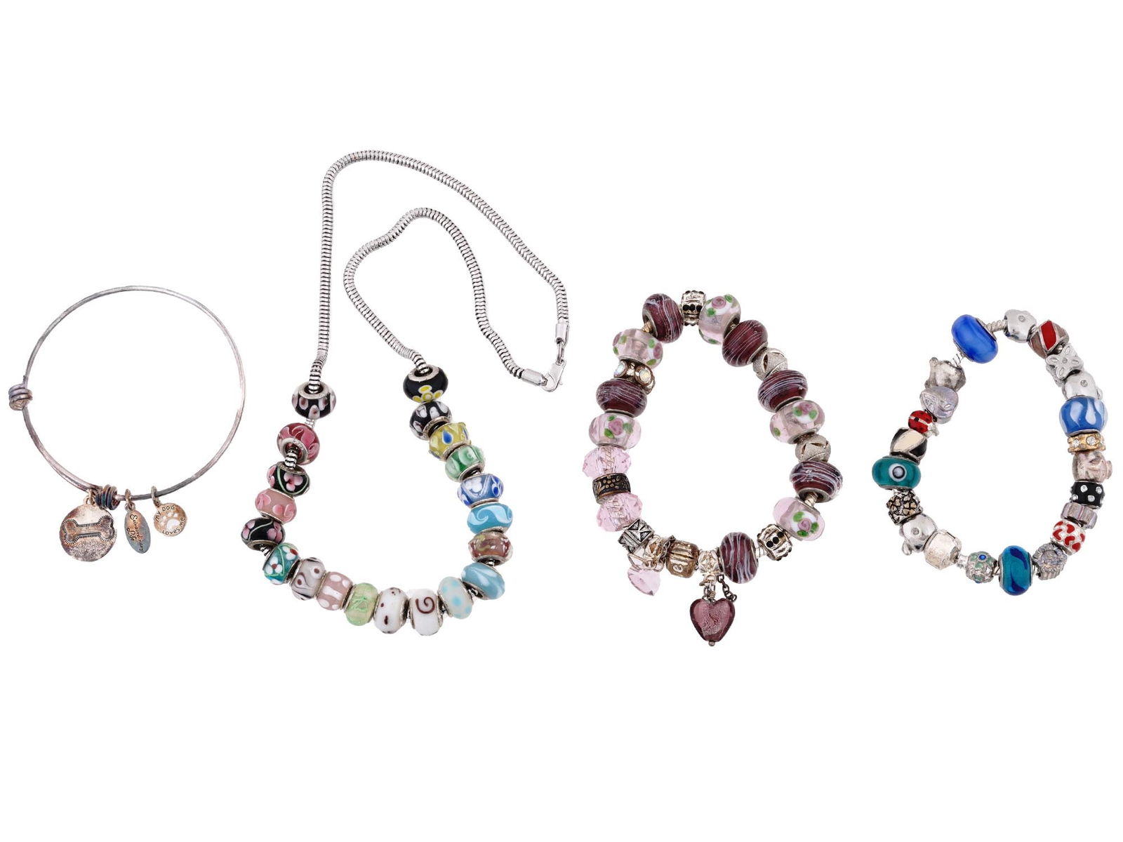 VINTAGE STERLING SILVER CHARM BRACELETS AND NECKLACE: A lot of vintage sterling silver jewelry. A total of 4 items. Two chain bracelets and a necklace with a total of 69 enamel and glass paste charms. An Extraordinaty Life bangle bracelet with dog-relate