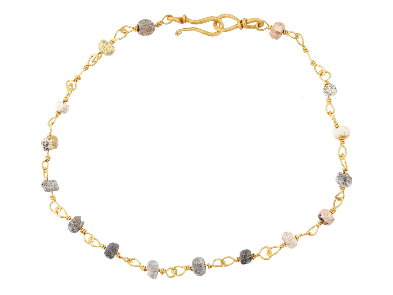 ANCIENT ROMAN GOLD BRACELET DESIGNED W GLASS BEADS: An ancient Roman bracelet, crafted with a combination of glass beads and gold wire. Circa: 100 to 300 AD. The bracelet showcases a series of intricately designed glass beads, interspersed with elegant