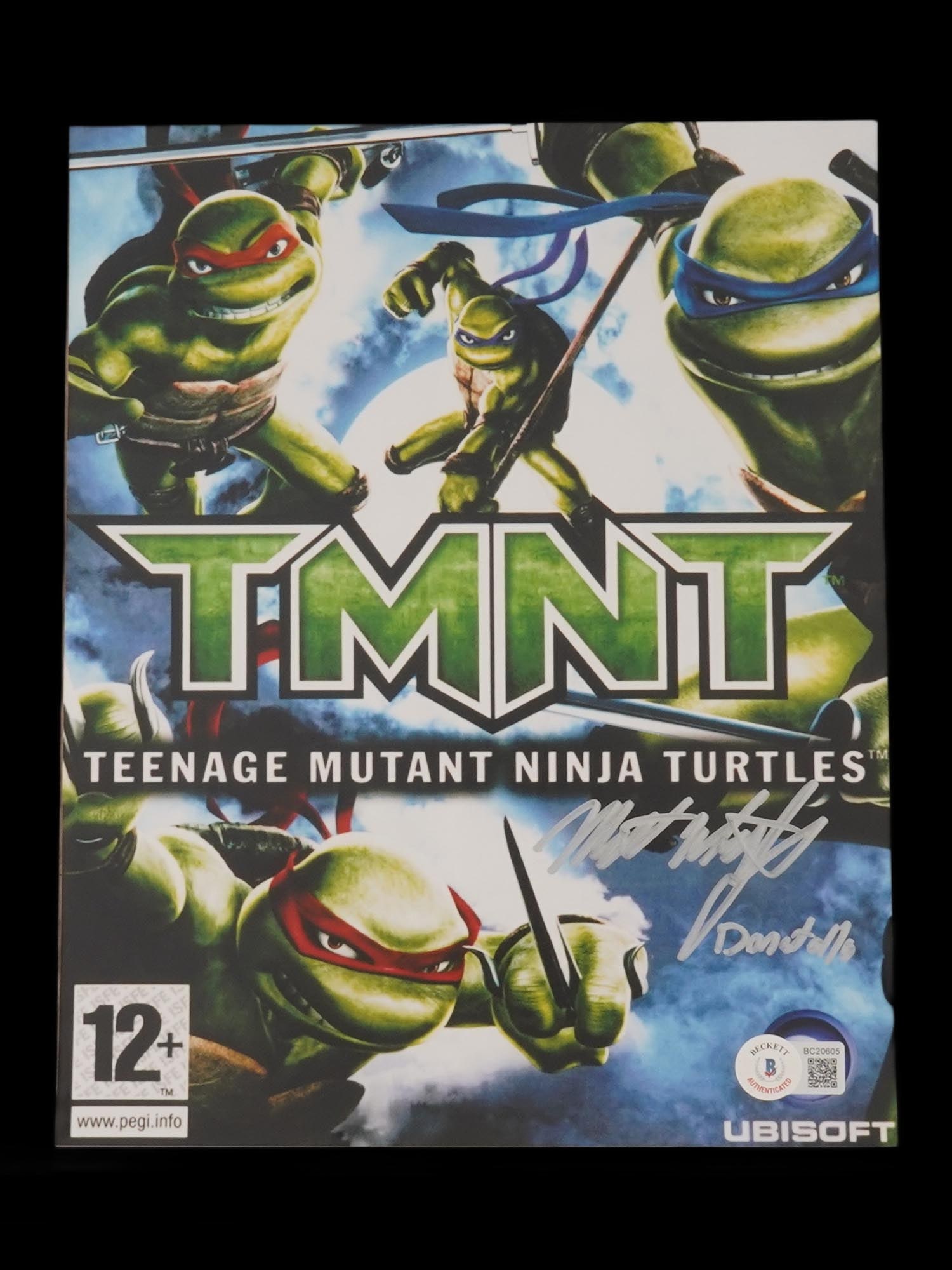NINJA TURTLES PRINT SIGNED WHITFIELD AUTHENTICATED: A color photograph print from the Teenage Mutant Ninja Turtles movie. Signed by Mitchell Whitfield. Inscribed, Donatello. Completed with a Beckett Authentication Certification Verification with a numb