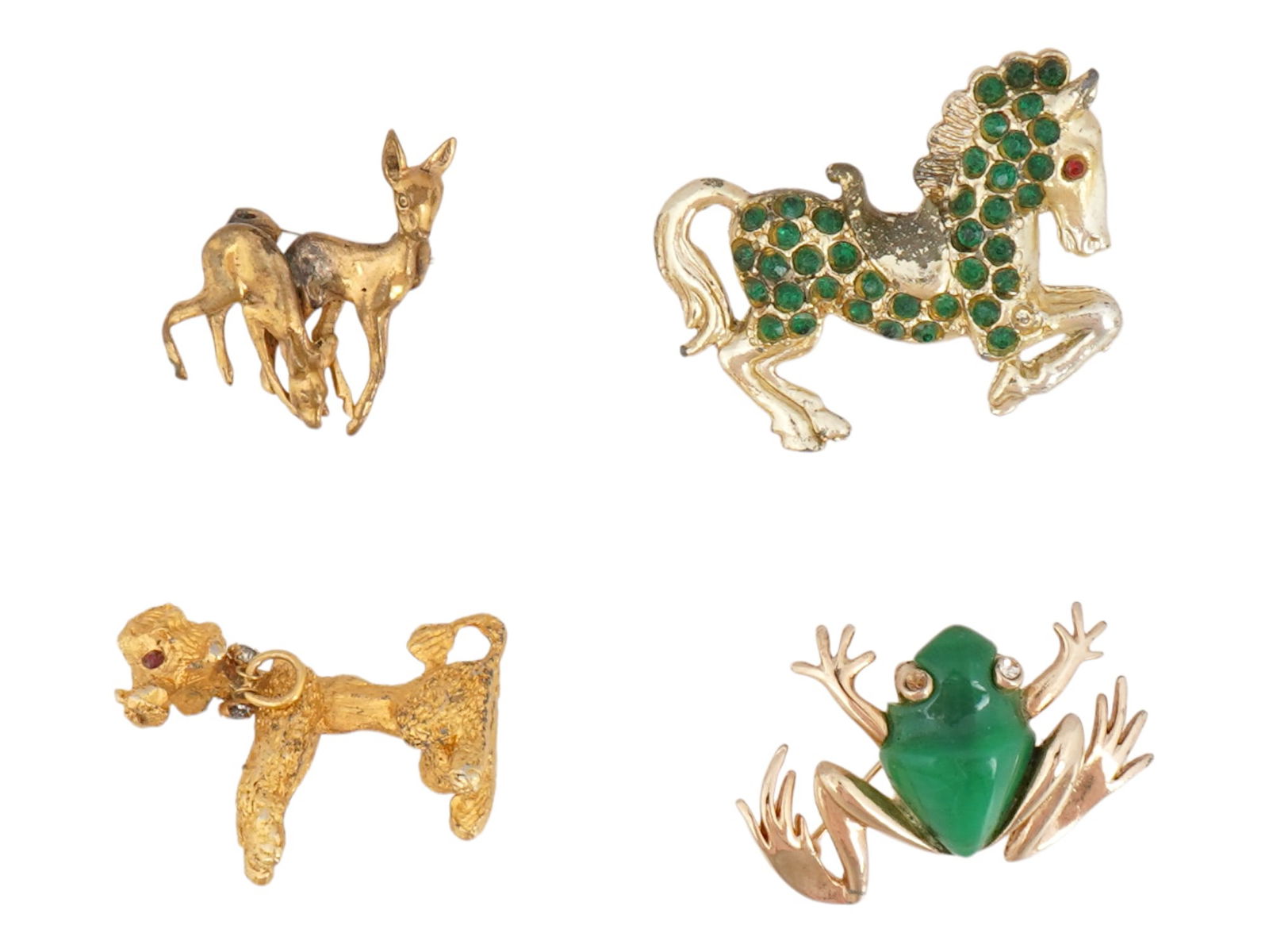 VINTAGE JEWELED ANIMAL PIN BADGES: A lot of 4 vintage gold-tone metal pin badges garnished with semiprecious stones and enamel. The pins represent a frog, a dog, a horse, and a deer. Costume Jewelry And Lapel Accessories. THIS L