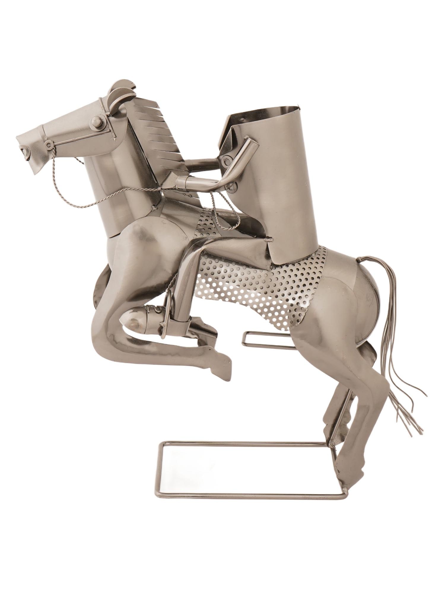 VINTAGE METAL HORSE RIDER WINE BOTTLE HOLDER: A vintage figurative wine bottle holder. Made of galvanized iron. The piece represents a jumping horse with a headless rider. Unmarked. Collectible Tableware And Barware, Table Setting, Equestrian Dec