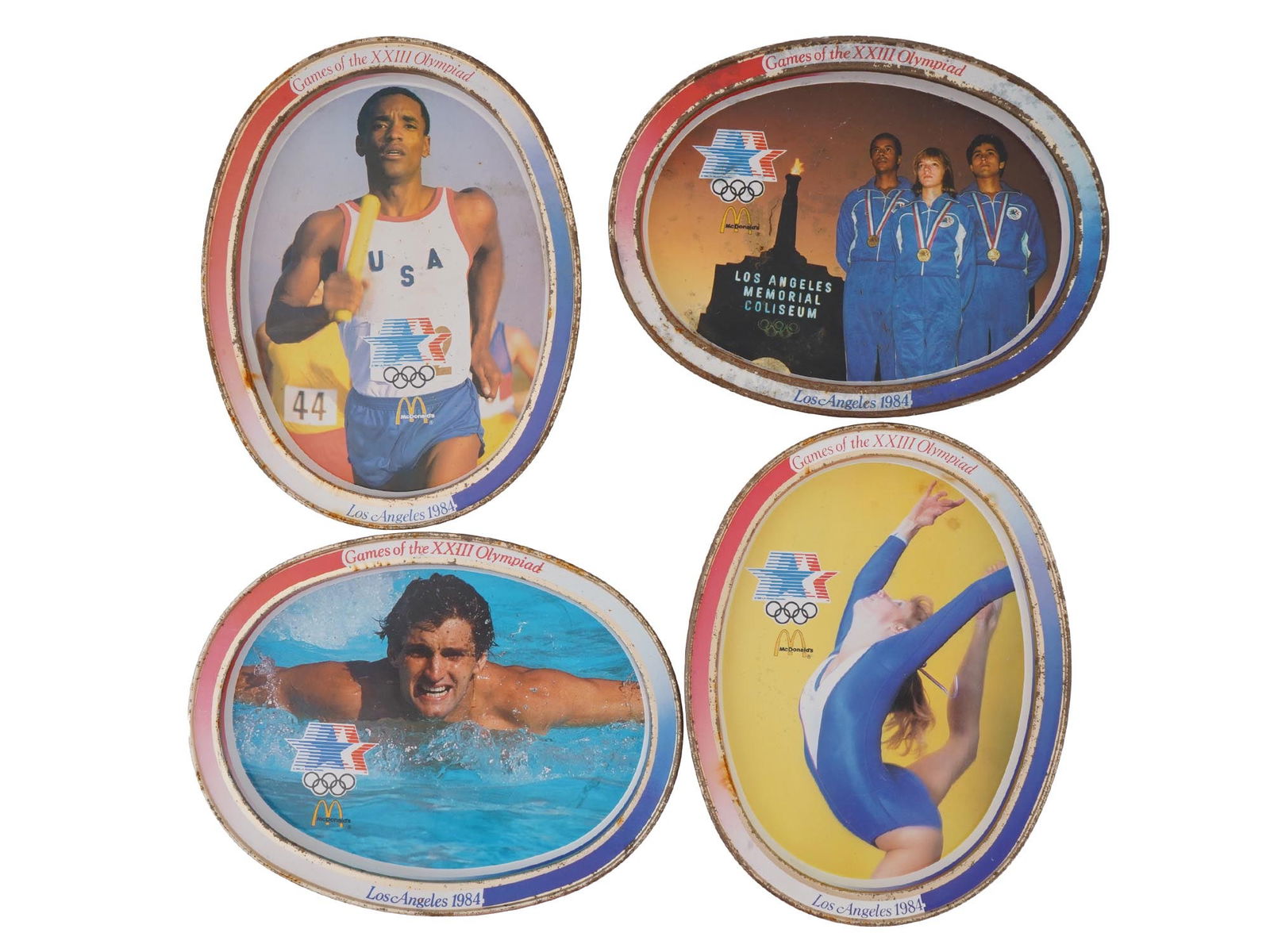 VINTAGE AMERICAN OLYMPIC GAMES MCDONALDS SERVING TRAYS: A group of six vintage American McDonalds promotional tin serving trays issued to commemorate the 1984 Los Angeles XXIII Olympic Games. Each tray features sportsmen imagery and the information about t