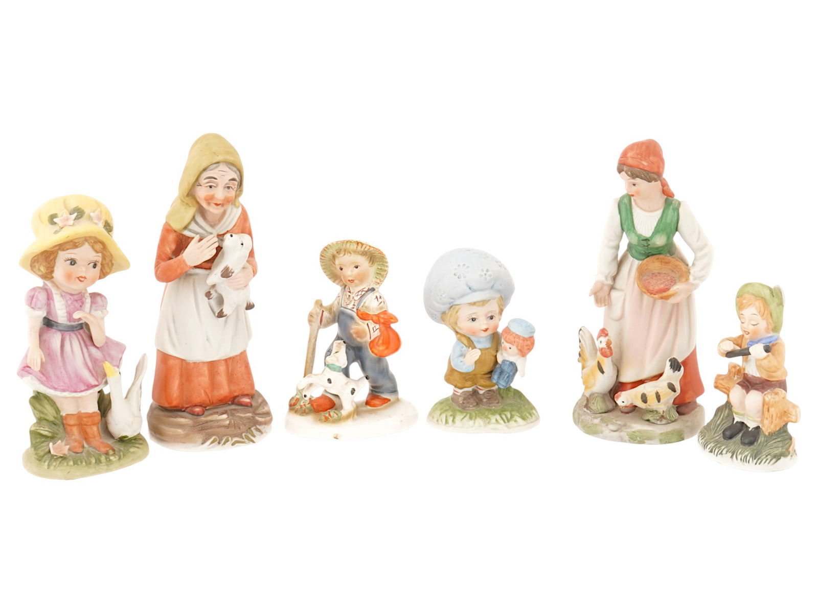 LOT OF SIX HUMMEL STYLE HAND PAINTED CERAMIC FIGURINES: A lot of six European polychrome hand painted ceramic figurines in Goebel Hummel style, depicting children and ladies in a pastoral, rural setting. The figures are individually sculpted and painted, p