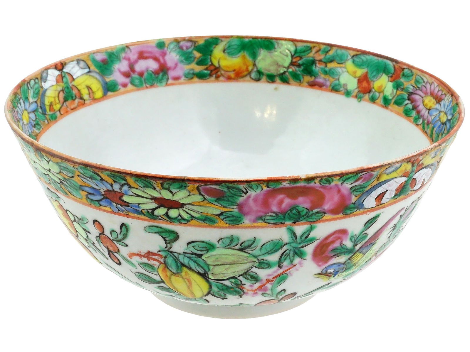 VINTAGE CHINESE FAMILLE ROSE PAINTED PORCELAIN BOWL: A vintage Chinese Famille Rose porcelain bowl. The exterior surface and inner rims of the bowl are adorned with birds, fruits, and flowers among foliage patterns. Circa the second half of the 20th cen