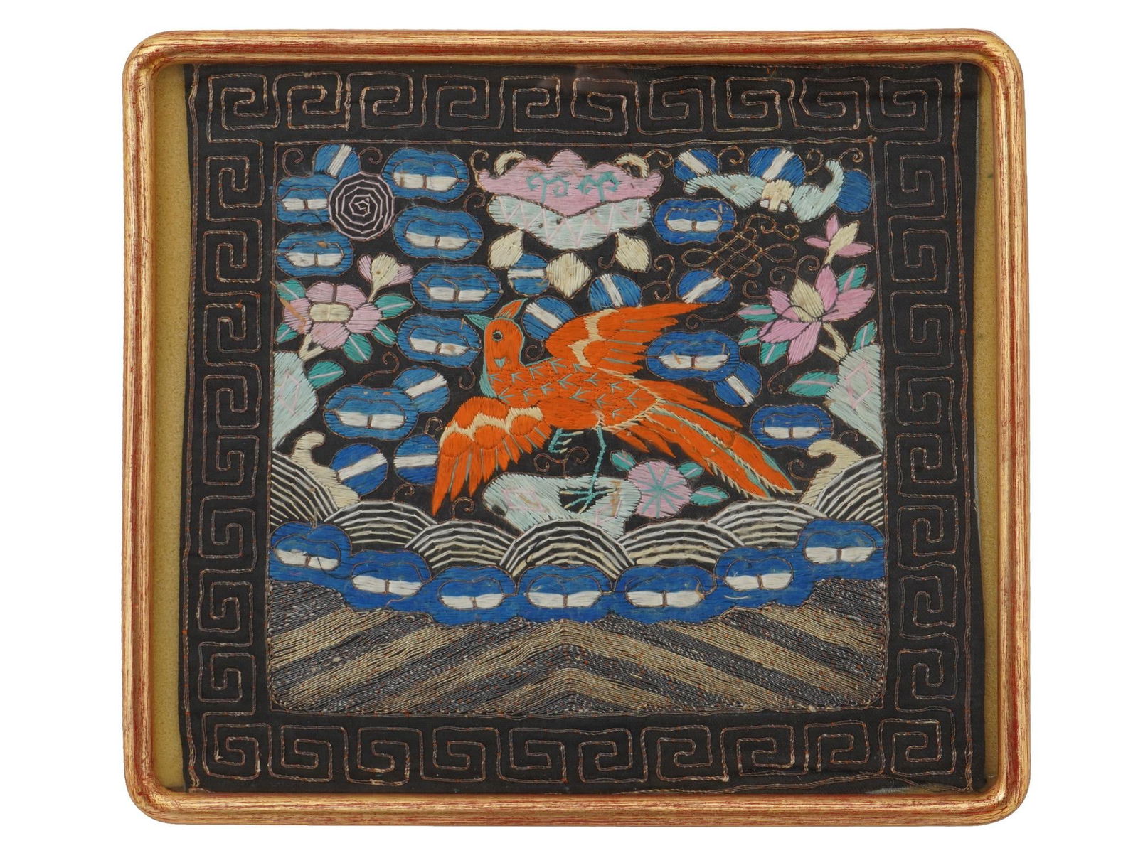 18TH CEN CHINESE QING EMBROIDERED SILK RANK BADGE: A 18th century antique Chinese Qing Dynasty 4th rank civil badge. The badge is adorned with a central orange bird insignia applied separately, set within stylised clouds and waves accented with Buddhi