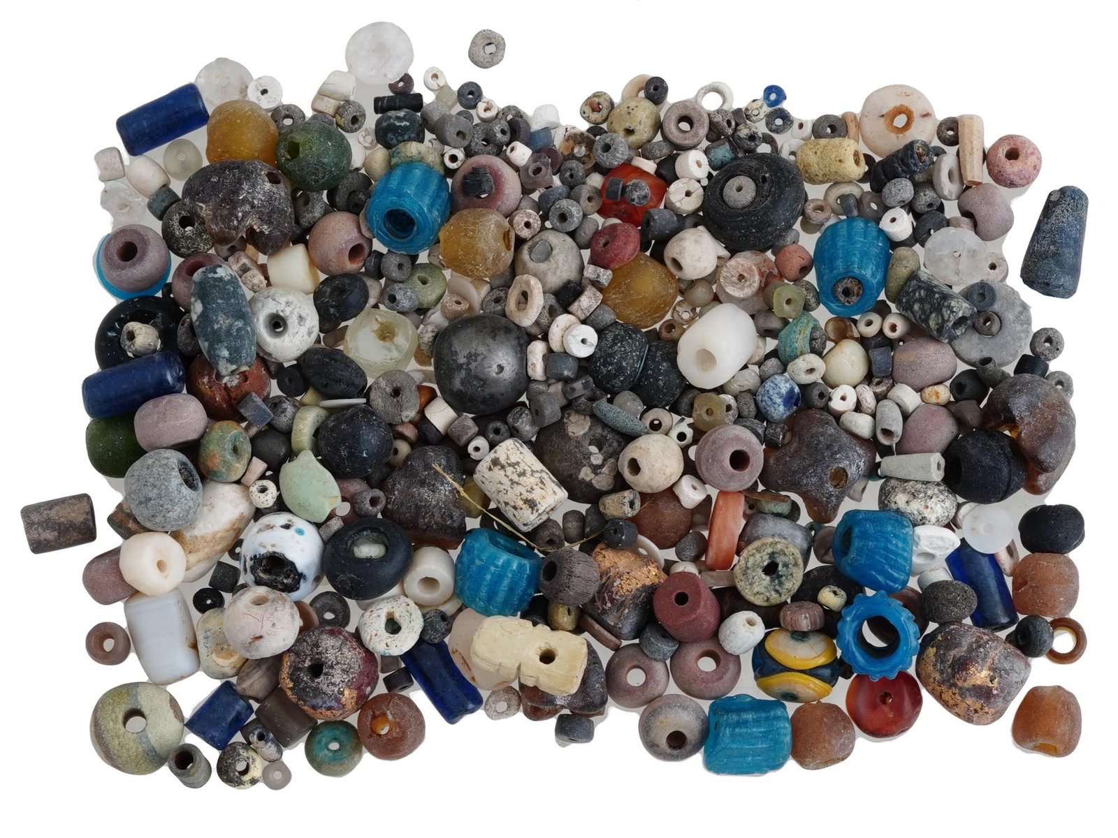 COLLECTION OF ANCIENT HOLY LAND GLASS AND STONE BEADS: A large collection of ancient Holy land area beads made of glass and stone. This extensive assortment showcases the artistic diversity and craftsmanship of ancient cultures, with beads in numerous sha