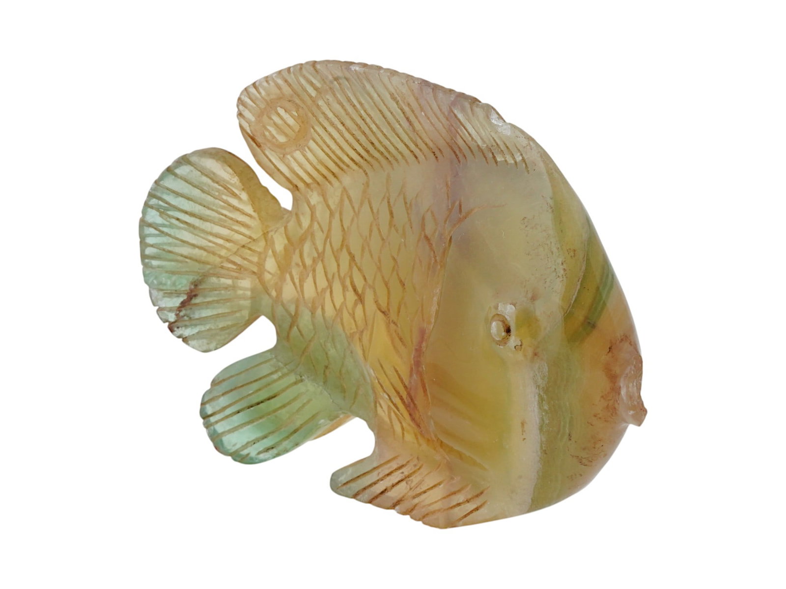 ANCIENT EGYPTIAN GREEN QUARTZ AMULET IN FORM OF A FISH: An ancient Egyptian green quartz amulet in the form of a fish, dating to the Ptolemaic Period, circa 305 to 30 BC. Finely carved from translucent green quartz, the fish symbolized fertility, abundance