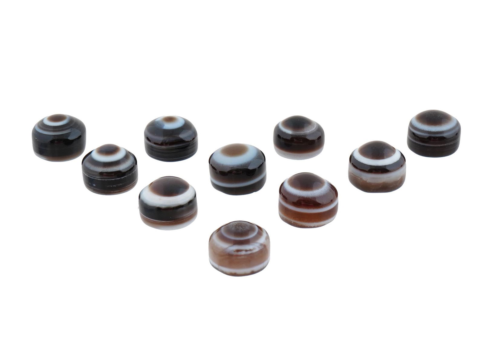 COLLECTION OF TEN EYE BANDED AGATE JEWELRY PENDANTS: A collection of ten eye-banded agate pendants, each hand-carved to highlight the natural concentric banding and distinctive eye formations characteristic of this gemstone.The stones display a range of