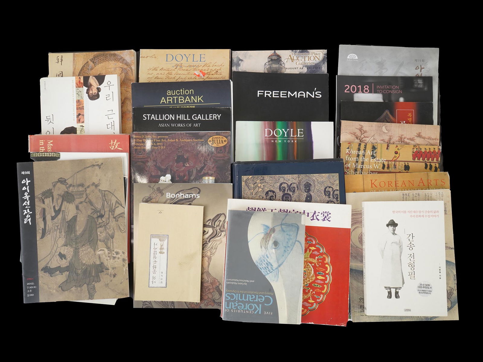 COLLECTION OF ORIENTAL ARTS BOOKS AND CATALOGS: A collection of books and catalogs primarily focused on Oriental Arts, specifically Korean and Chinese art. There are catalogs from auction houses such as Sothebys, Christies, Bonhams, Doyle, Freemans