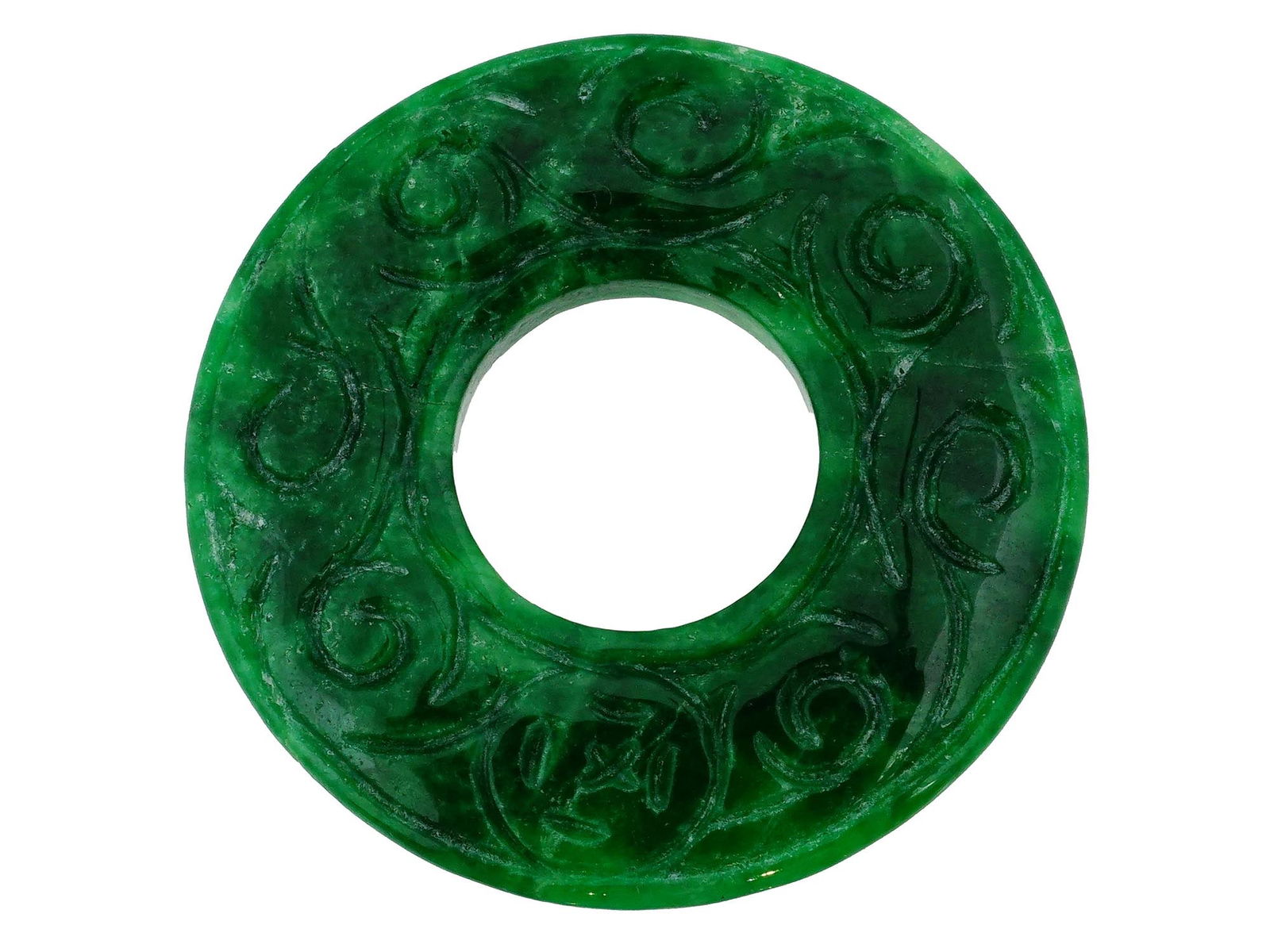 CHINESE HAND CARVED GREEN JADE BI DISC PENDANT: A Chinese hand carved celadon green Jade bi disc amulet sculpture representing a flat carved and polished disc with a circular hole in the center. The ware is adorned with an engraved swirl motif. The