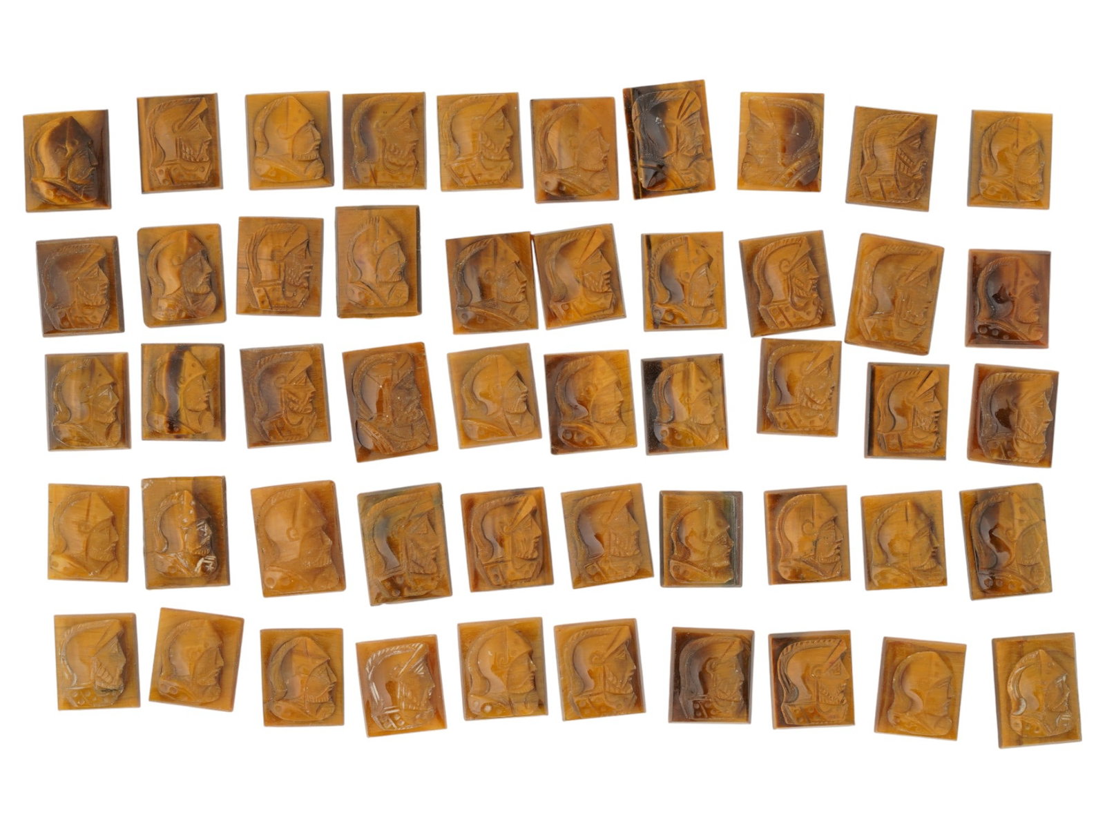 COLLECTION OF PORTRAIT CARVED TIGERS EYE CAMEOS: A collection of hand carved tigers eye cameos. A total of 50 items. Each piece features a knight profile portrait rendered in high relief. Square shape. Collectible Jewelry And Glyptic Art, Sculpture.