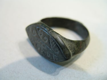 BRONZE RING WITH ENGRAVING.