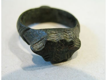 BRONZE RING WITH ENGRAVING.