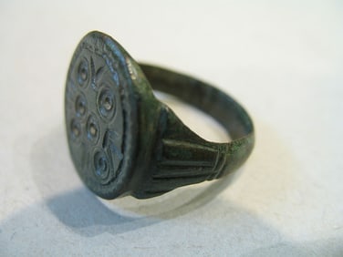 BRONZE RING WITH ENGRAVING.