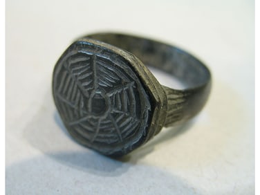 BRONZE RING WITH ENGRAVING.