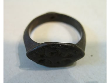 BRONZE RING WITH ENGRAVING.
