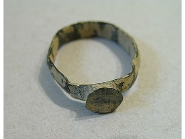 BRONZE RING WITH ENGRAVING.