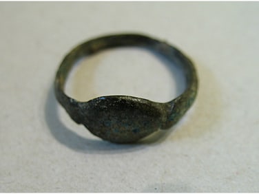 BRONZE RING WITH ENGRAVING.