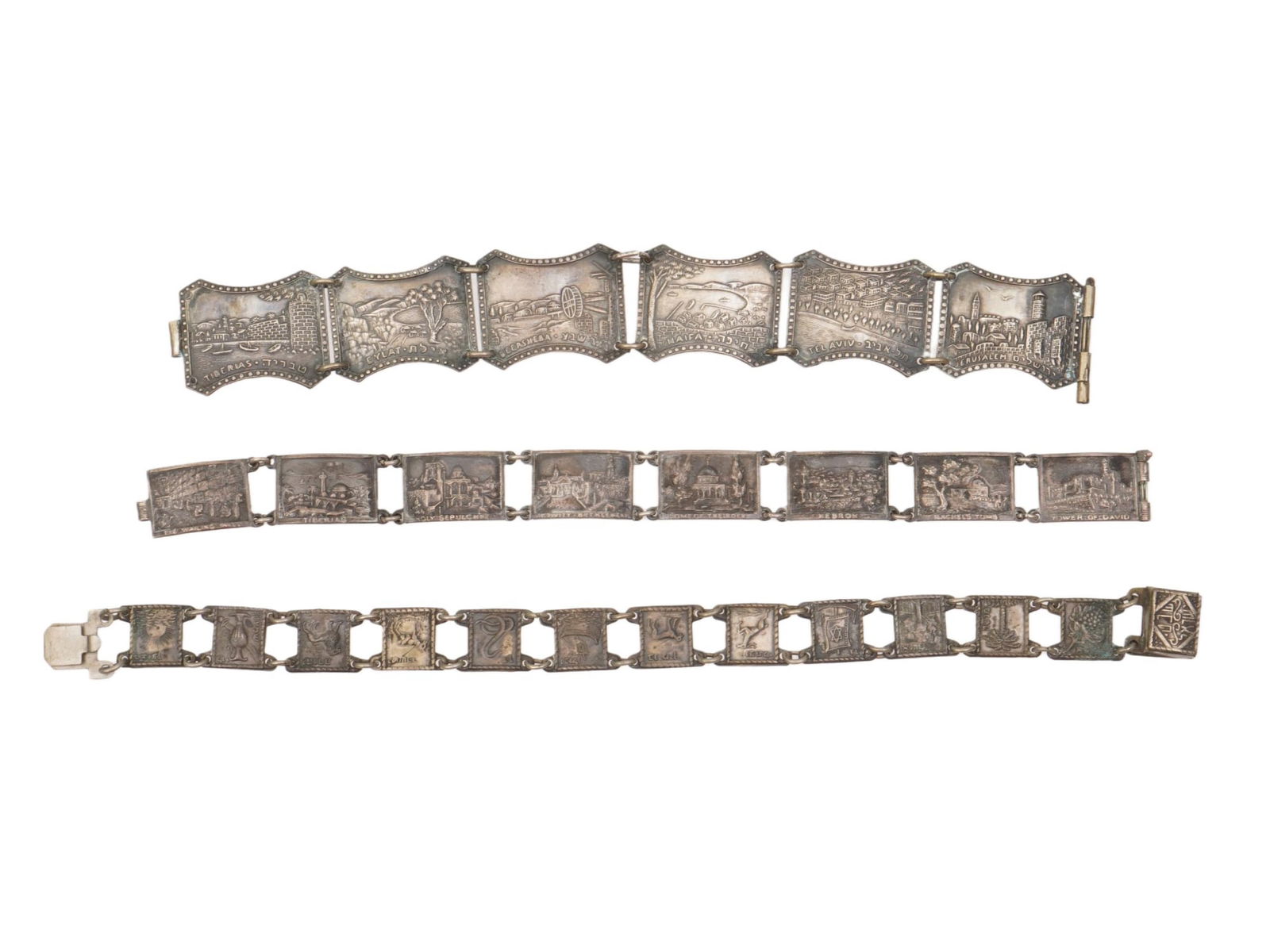 LOT OF JUDAICA ENGRAVED LINK DESIGN SILVER BRACELETS: A lot of three Judaica Silver bracelets. Each bracelet is made in a link design. Each link is adorned with an engraved design representing rural scenes, cityscapes, landscapes, symbols, Jerusalem view