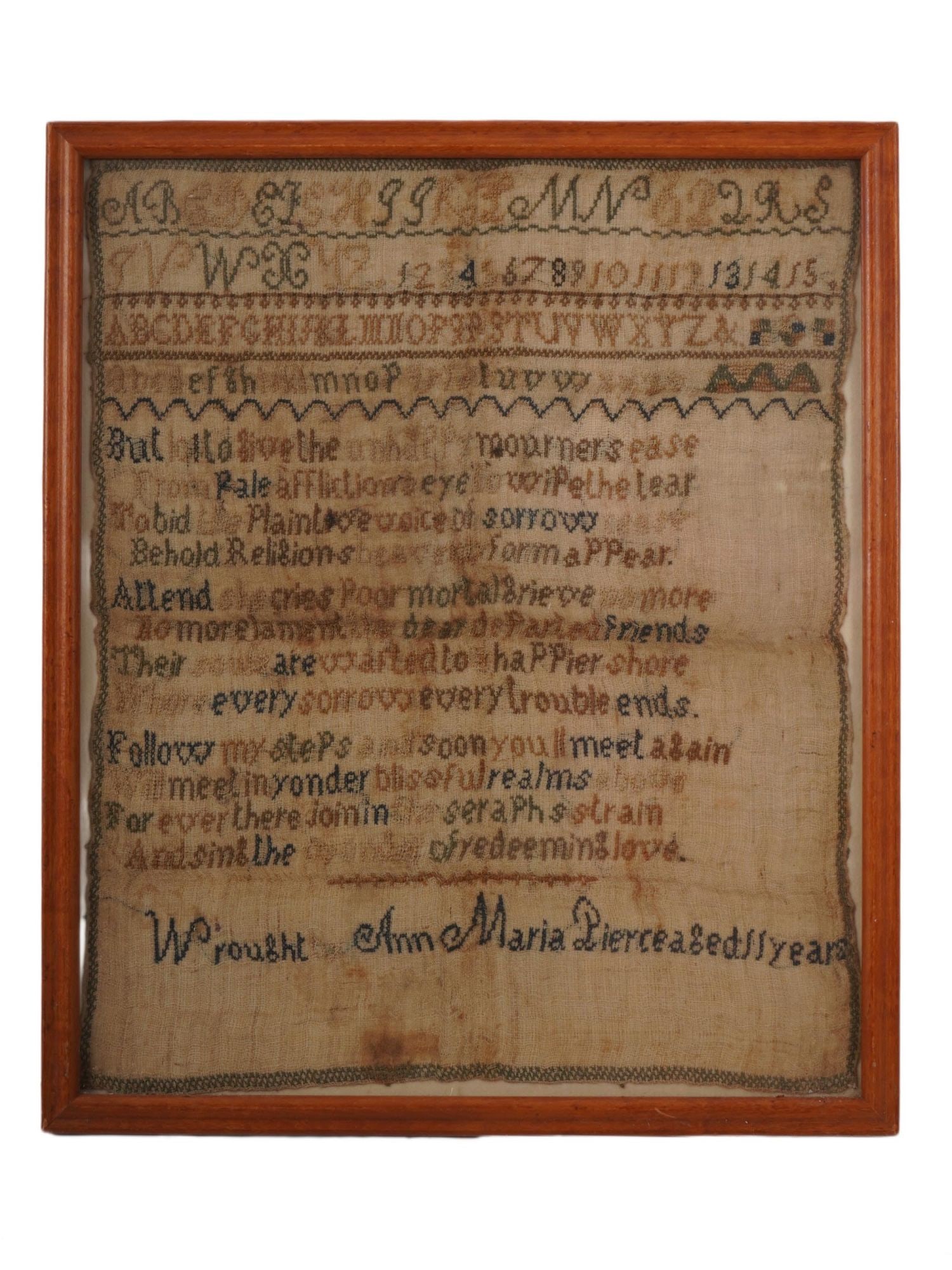 ANTIQUE ENGLISH HANDCRAFTED SAMPLER EMBROIDERY ON LINEN: An antique English handcrafted sampler embroidery on linen piece by Anna Maria. Circa 18th to 19th century. The item is mourning embroidery featuring the alphabet, numbers, and a religiously themed ed