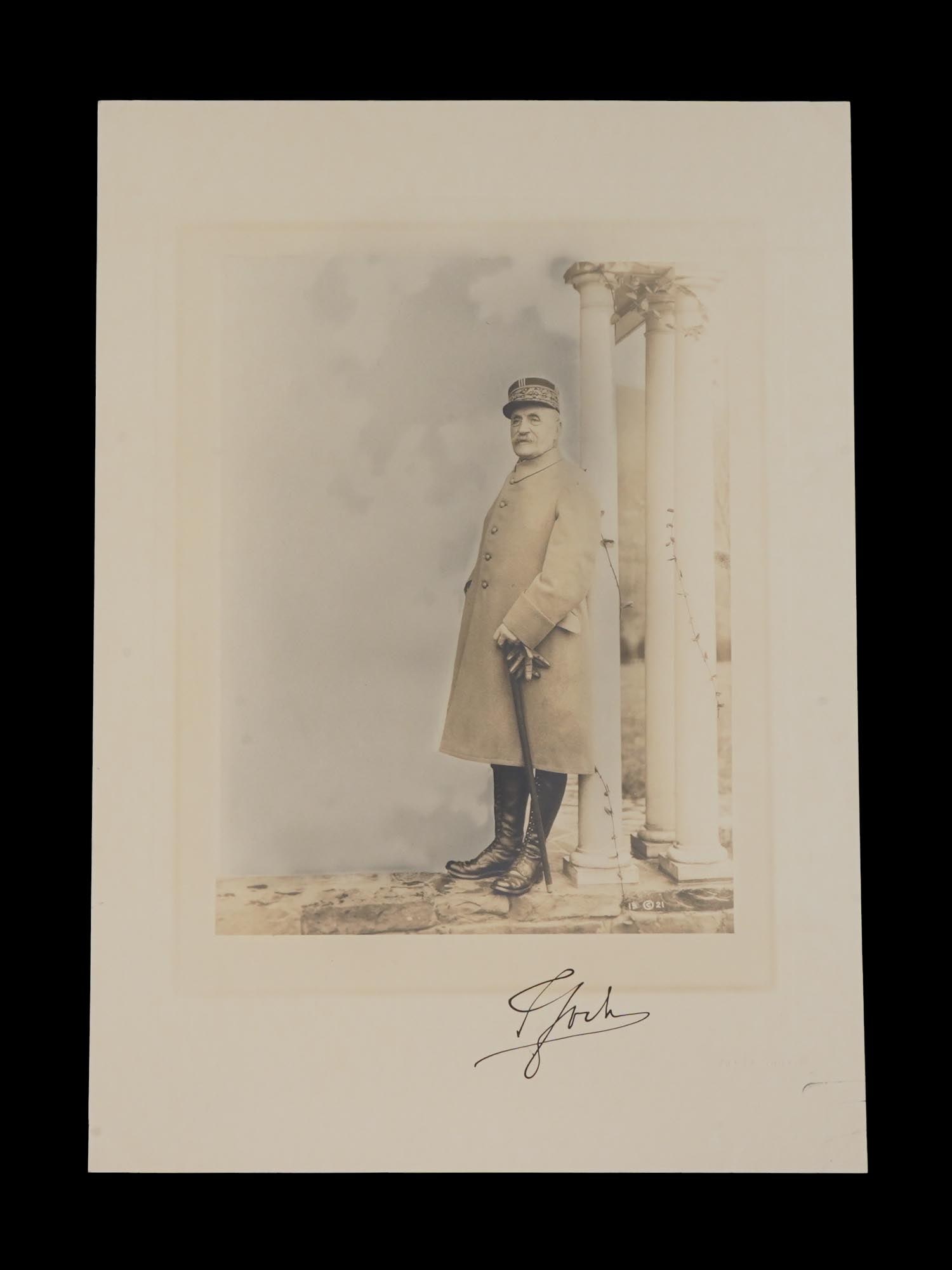 AMERICAN PORTRAIT PHOTO FRANK MOORE FERDINAND FOCH: A full length hand tinted portrait photograph by Frank Moore depicting Ferdinand Foch, showing him in overcoat, boots, and uniform cap bearing the characteristic bands of oak leaves. Ferdinand Foch,