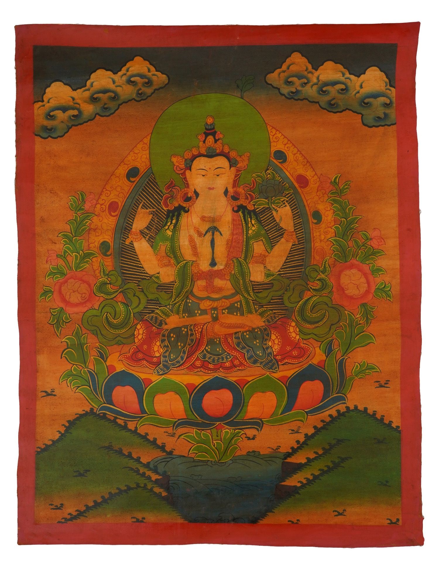 TIBETAN BUDDHIST THANGKA HAND PAINTING ON FABRIC: A Tibetan Buddhist Thangka polychrome painting on cotton. The thangka features a symmetrical composition with a central Buddha figure seated on a lotus flower. The Thangka was used in religious proces