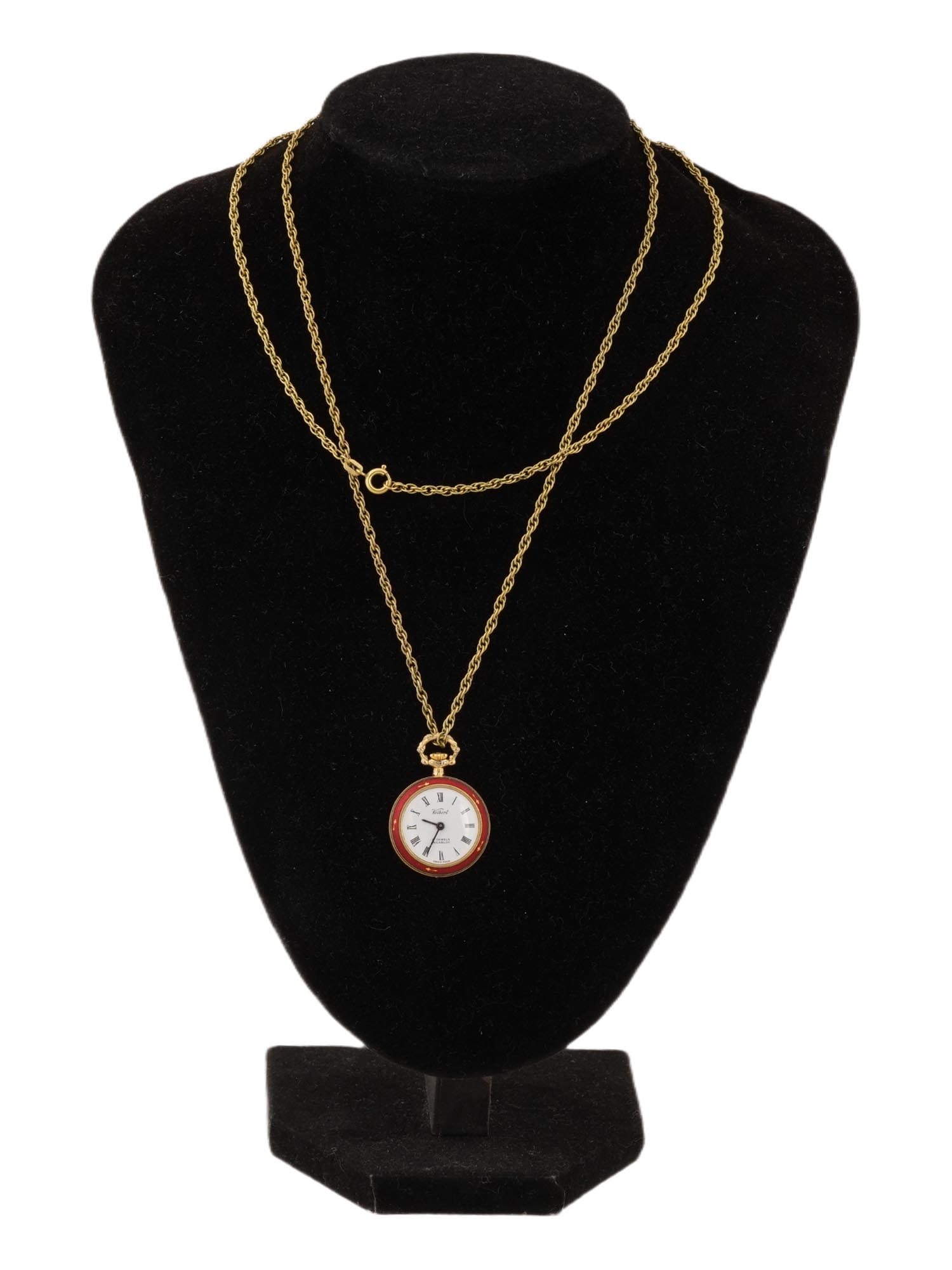 KELBERT SWISS MADE 17 JEWELS PENDANT WATCH W CHAIN: A vintage womens Kelbert 17 Jewels pendant watch with a Swiss made Incabloc movement. Gold case with a vibrant red enamel bezel and Roman numerals on a white dial. Marked on the dial. Completed with a