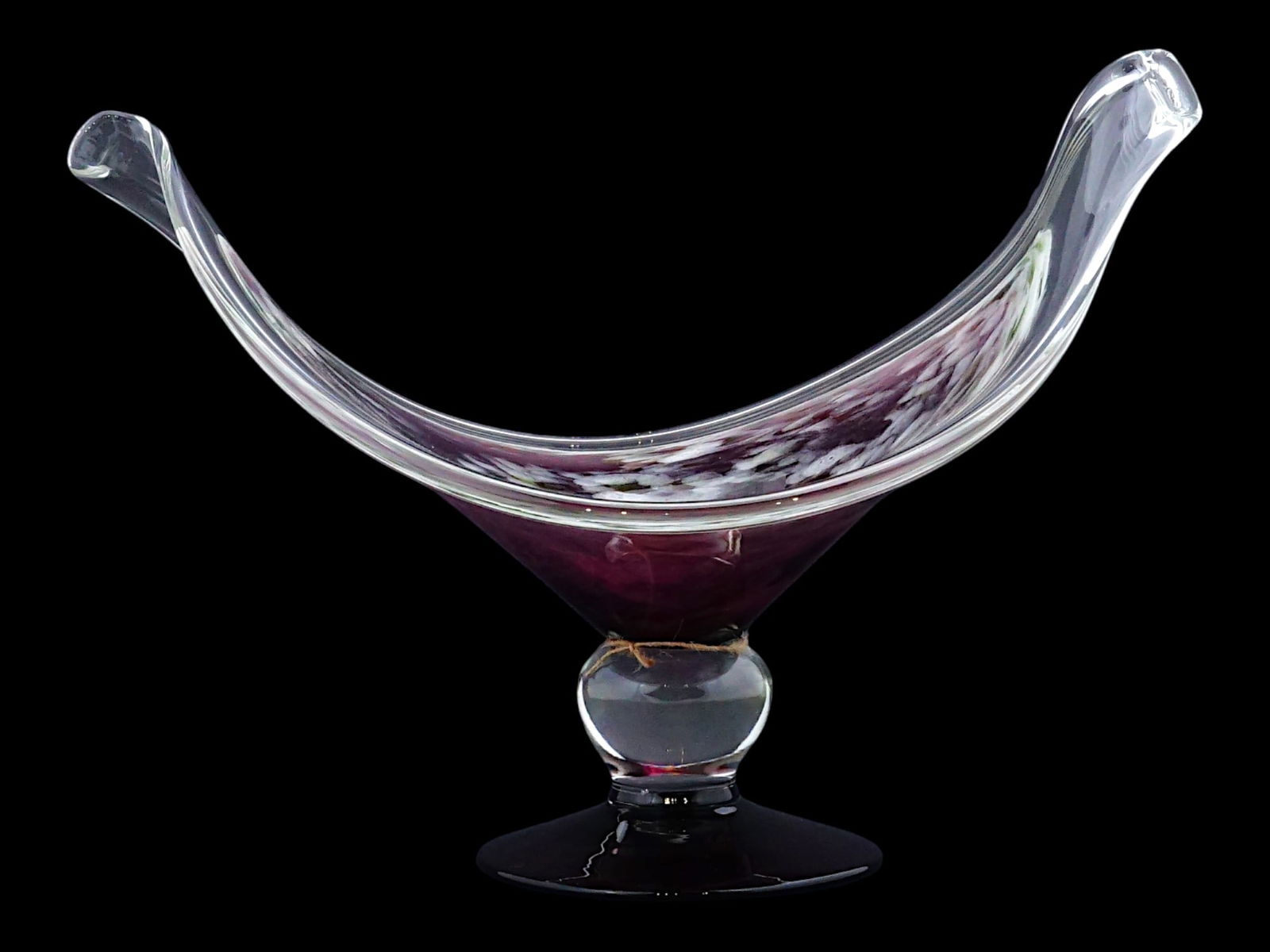 ITALIAN MURANO HAND BLOWN ART GLASS CENTERPIECE BOWL: An Italian Murano hand blown art glass centerpiece bowl. The piece is crafted in the elegant, freeform shape. The glass features a core of purple, white, and green swirling patterns which give it a mo