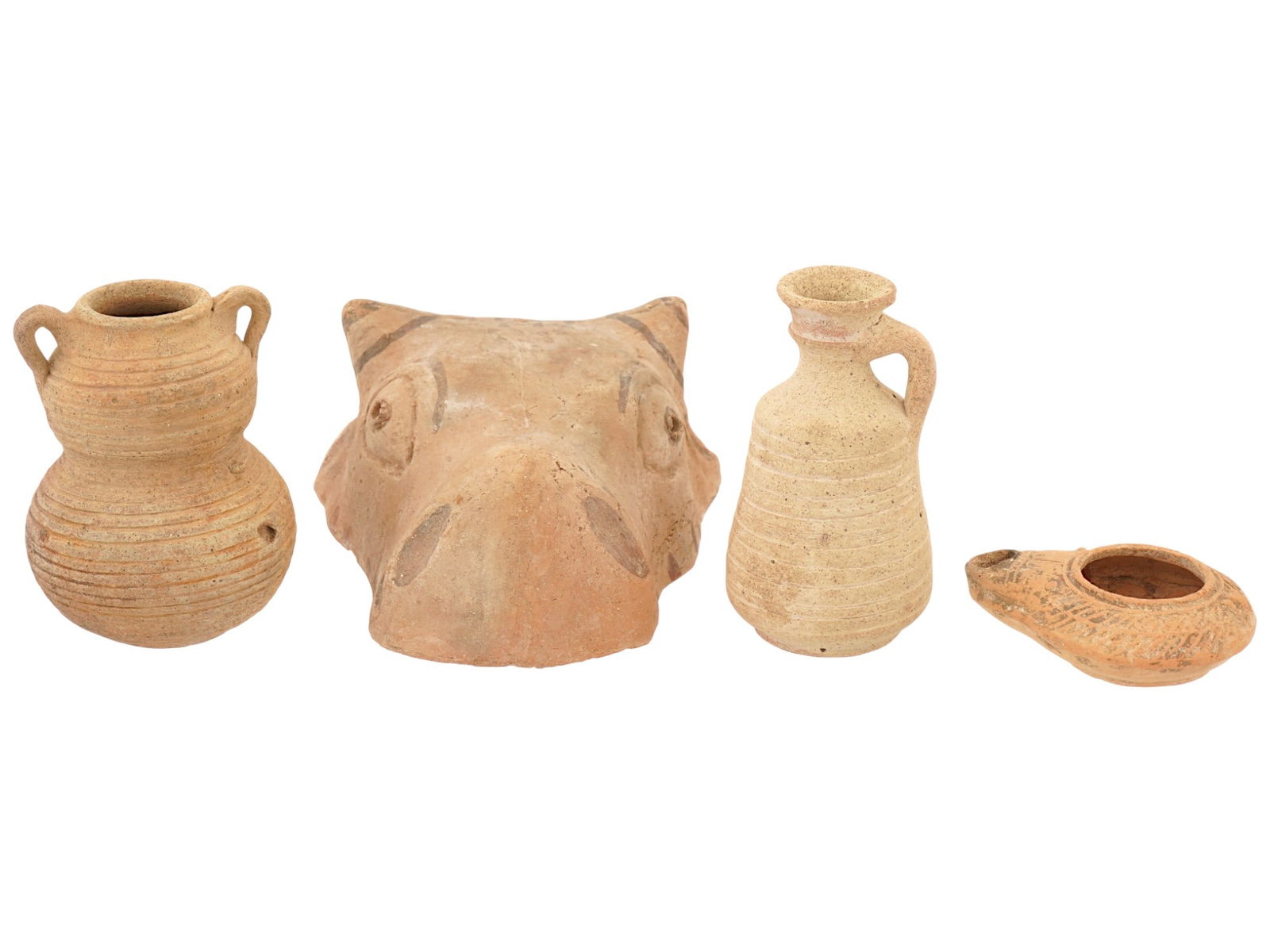 ANCIENT ROMAN EMPIRE TERRACOTTA JARS AND BULL MASK: A lot of Ancient Roman terracotta pieces. Imperial Rome era, ca. 100 to 500 AD. A total of 4 items. A pitcher with a narrow neck and striped pattern. A painted bull head mask. An oil lamp with striped