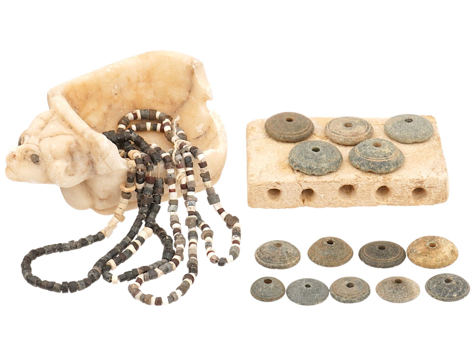 ANCIENT ARTIFACTS MARBLE ALTAR NECKLACES SPINDLE WHORLS: A collection of ancient artifacts dating from the 1000 BC to 200 AD and later. The lot includes a carved marble altar fragment with mythological animal motifs, two Roman or Near Eastern glass bead nec
