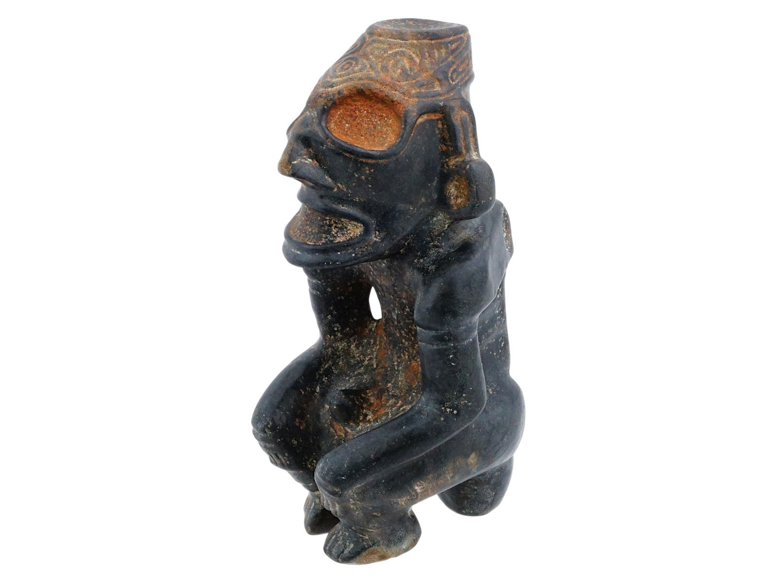 RARE TAINO MANNER HARD STONE CEREMONIAL IDOL FIGURINE: A rare Taino manner carved hard stone idol figurine can be used as a snuff ceremonial pedestal. The figure is depicted in a squatting or kneeling position, with an emaciated body, prominent ribs and w