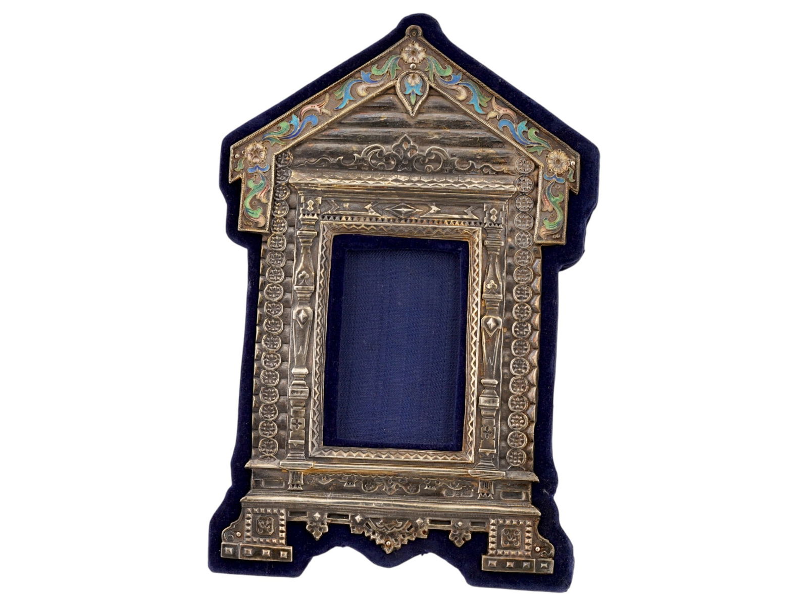 RUSSIAN SILVER ENAMEL CARVED SLAVIC IZBA PICTURE FRAME: A Russian silver picture frame in the form of a carved Izba, traditional Slavic village house. Decorated with stylized floral polychrome enamel patterns created in the cloisonne technique. The back