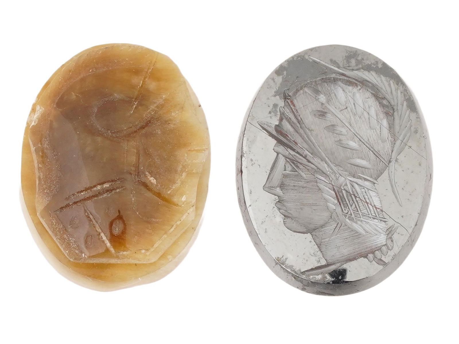 PAIR OF VINTAGE HAND CARVED STONE CAMEOS: A pair of vintage hand-carved oval cameos. Amber cameo featuring a zoomorphic figure. Mirror cameo with a profile portrait of a Roman soldier. Collectible Gemstone Carvings, Sculpture, Glyptic Art, Je