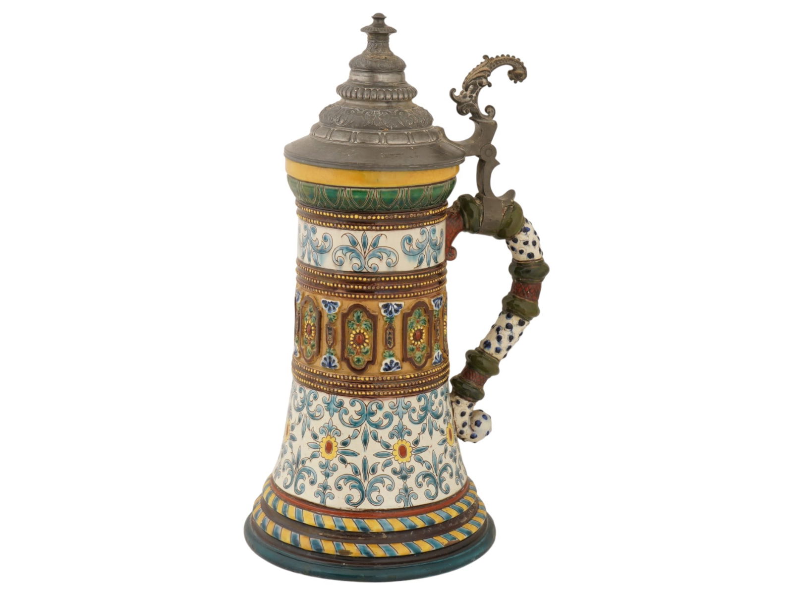 ANTIQUE GERMAN HAND PAINTED CERAMIC PEWTER BEER STEIN: An antique German beer mug stein with a pewter lid and a richly decorated, embossed and painted ceramic body. The ware is adorned with hand painted floral, foliage and geometrical ornaments. A handle