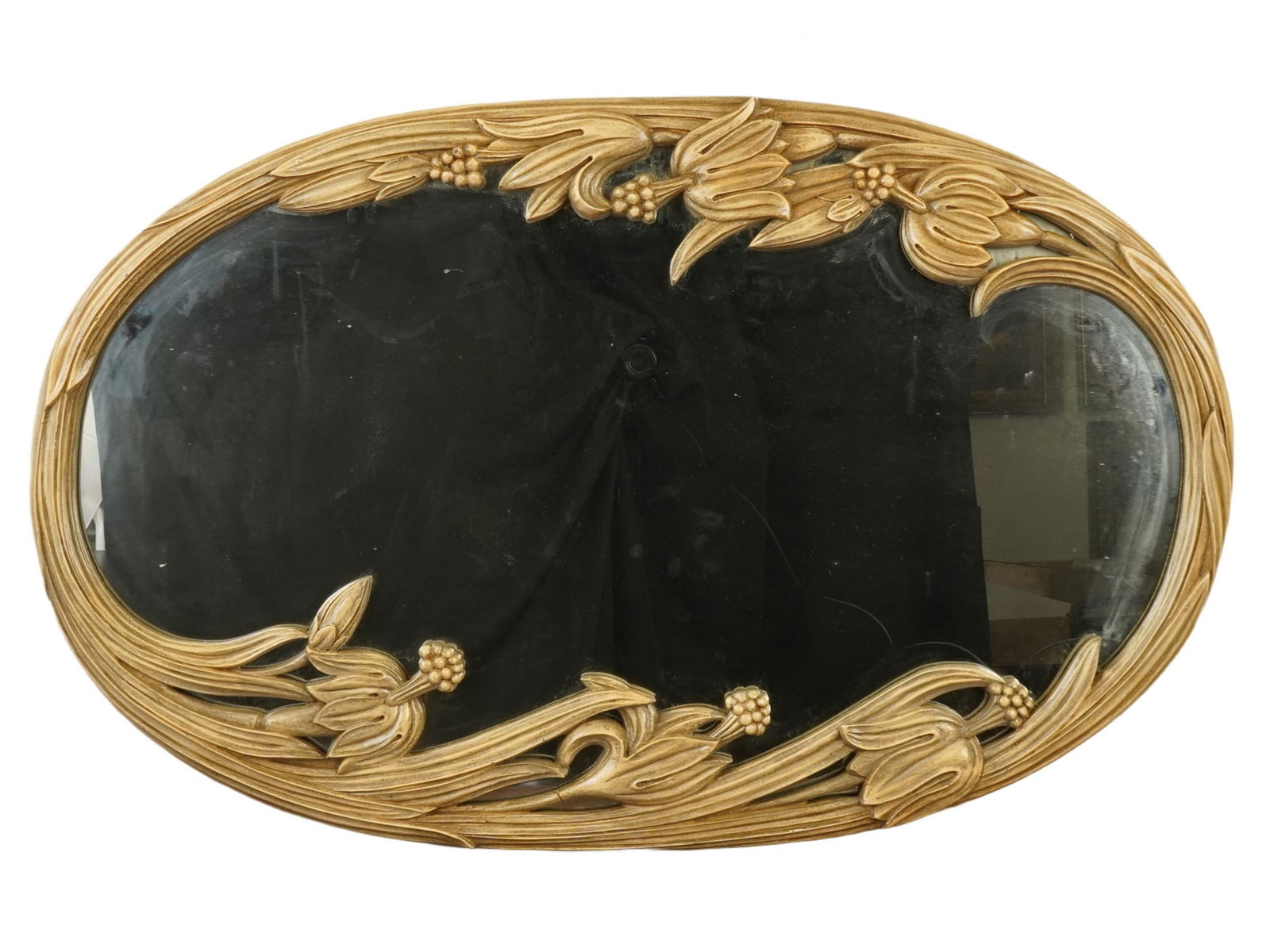 LARGE VINTAGE AMERICAN ART NOUVEAU WALL MIRROR: A large vintage American Art Nouveau wall mirror. The oval mirror is decorated with large gilt relief floral and leaf motifs. Labeled on the back side. Antique and Vintage American Mirrors, Wall Art,