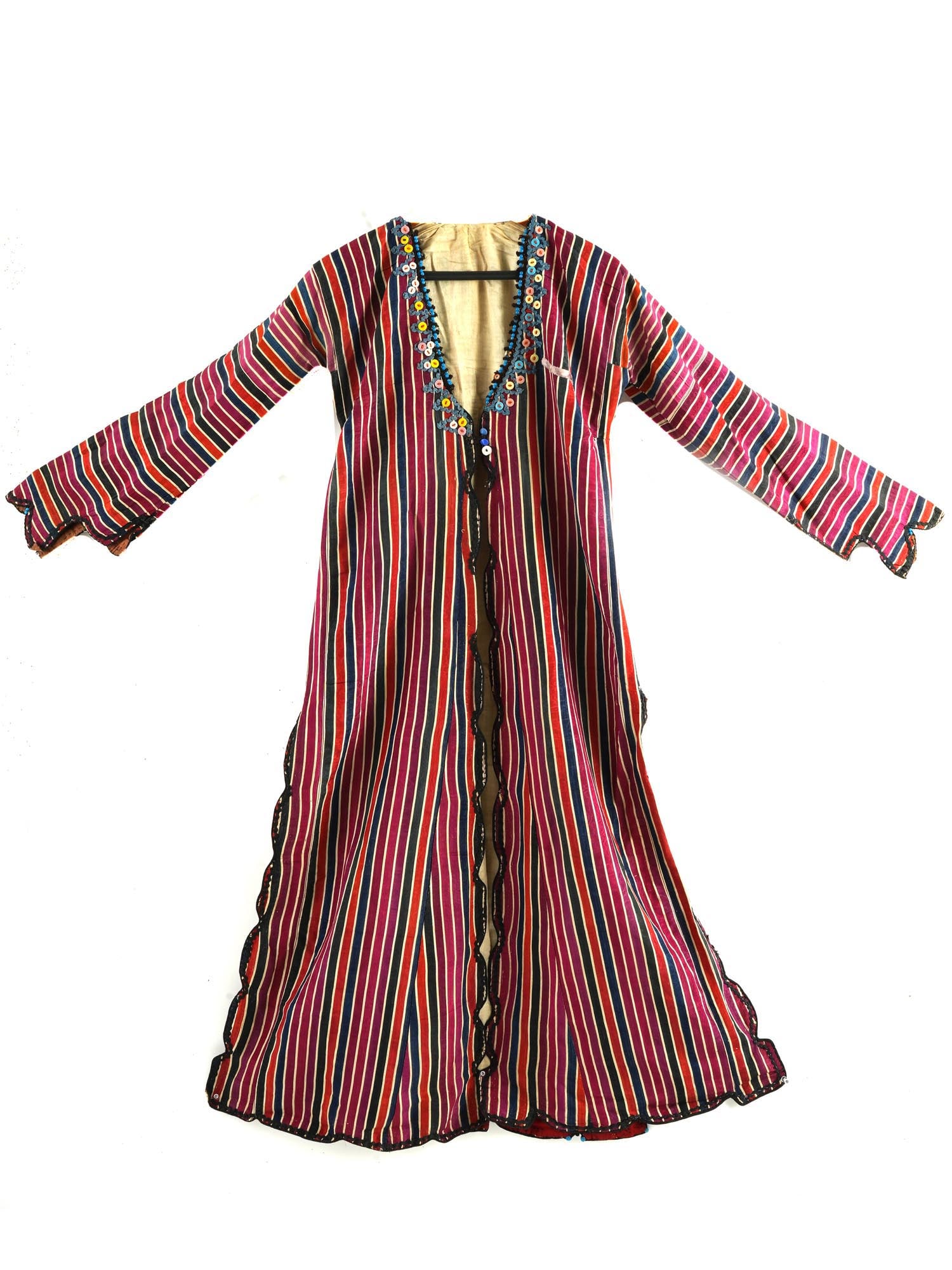 ANTIQUE TURKISH OTTOMAN SILK WOMENS ROBE: An antique Turkish Ottoman hand crafted silk womens robe. Circa mid to late 18th century. The robe is hand crafted and decorated with vertical stripes in a warm color scheme. The wavy edges are finish