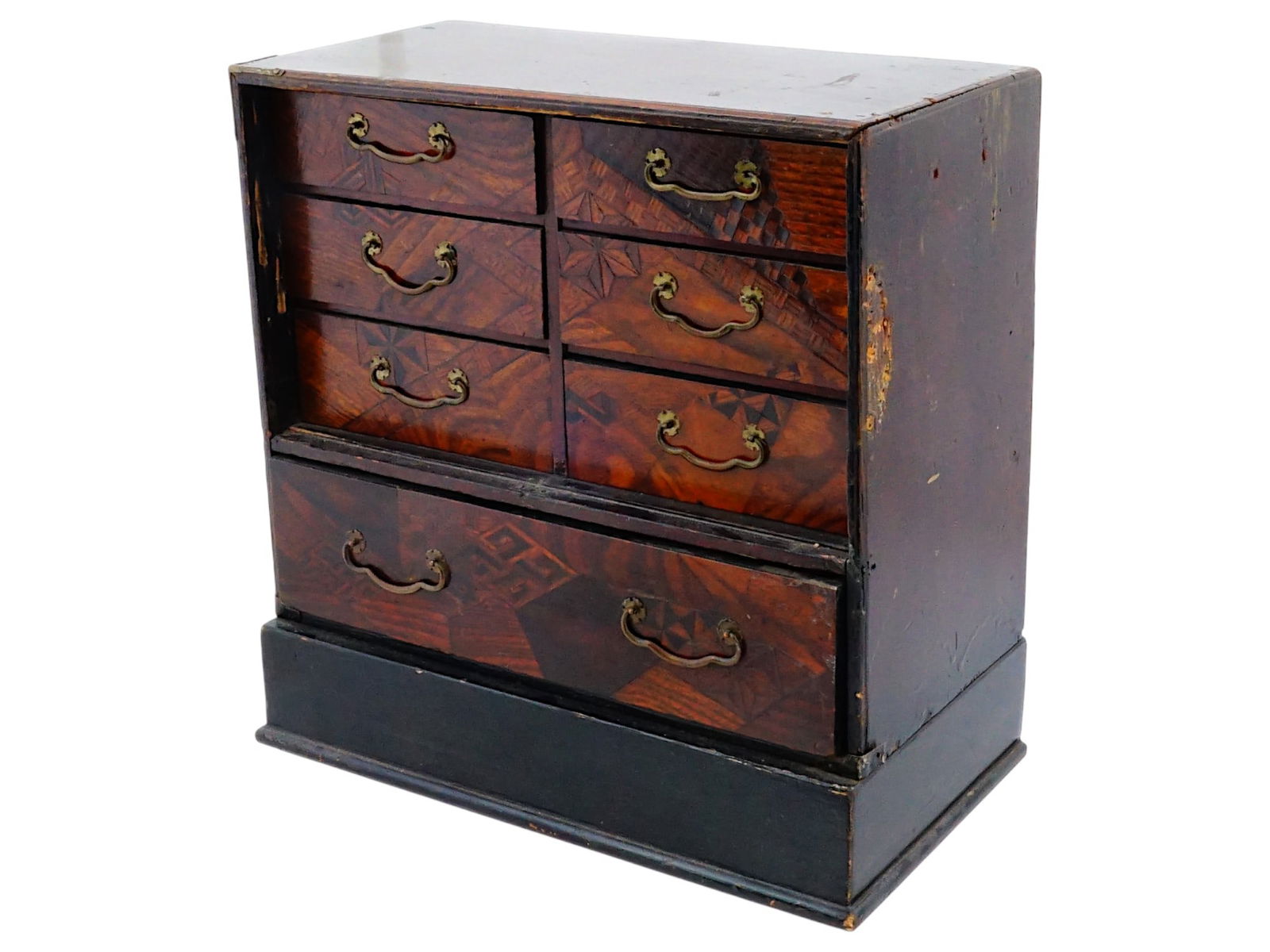 ANTIQUE JAPANESE MEIJI PERIOD WOODEN TANSU CHEST: An antique Japanese Meiji period wooden Tansu chest, miniature cabinet. Circa the mid 19th to early 20th century. The rectangular piece with 7 drawers, each decorated with Yosegi inlay and featuring a