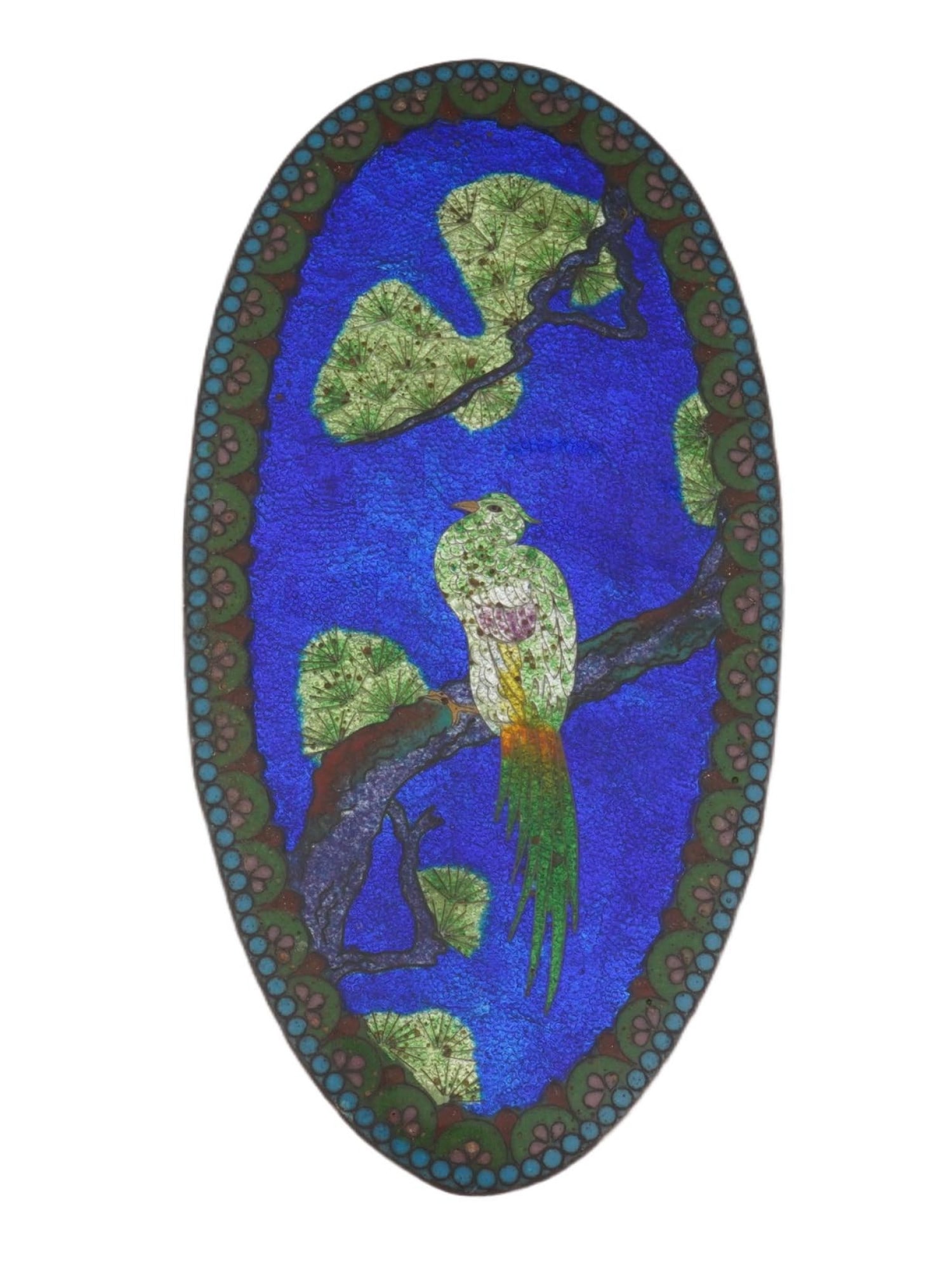 MINIATURE ASIAN CLOISONNE ENAMEL METAL PLAQUE W BIRD: A miniature Asian cloisonne enamel metal oval shaped plaque depicting a multicolored image with a bird perched on a tree over a blue ground. Surrounded by various floral and dot patterns. Antique And