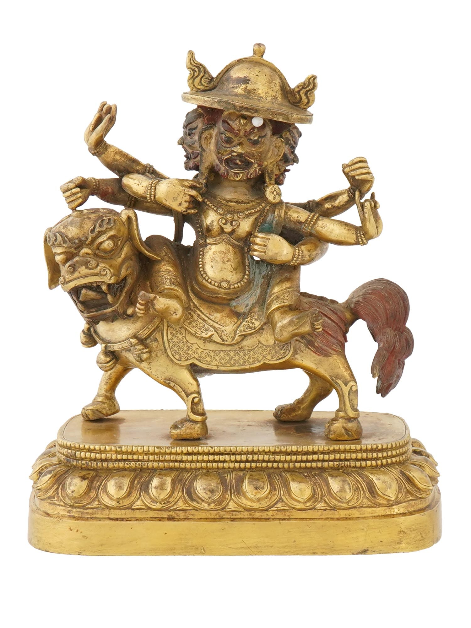 TIBETO CHINESE GILT BRONZE VAISHRAVANA DEITY FIGURINE: A Tibeto Chinese gilt bronze figurine depicting a three-headed, six-armed deity Vaishravana riding a mythical creature. The creature resembles a lion like animal with a fierce expression and is mounte