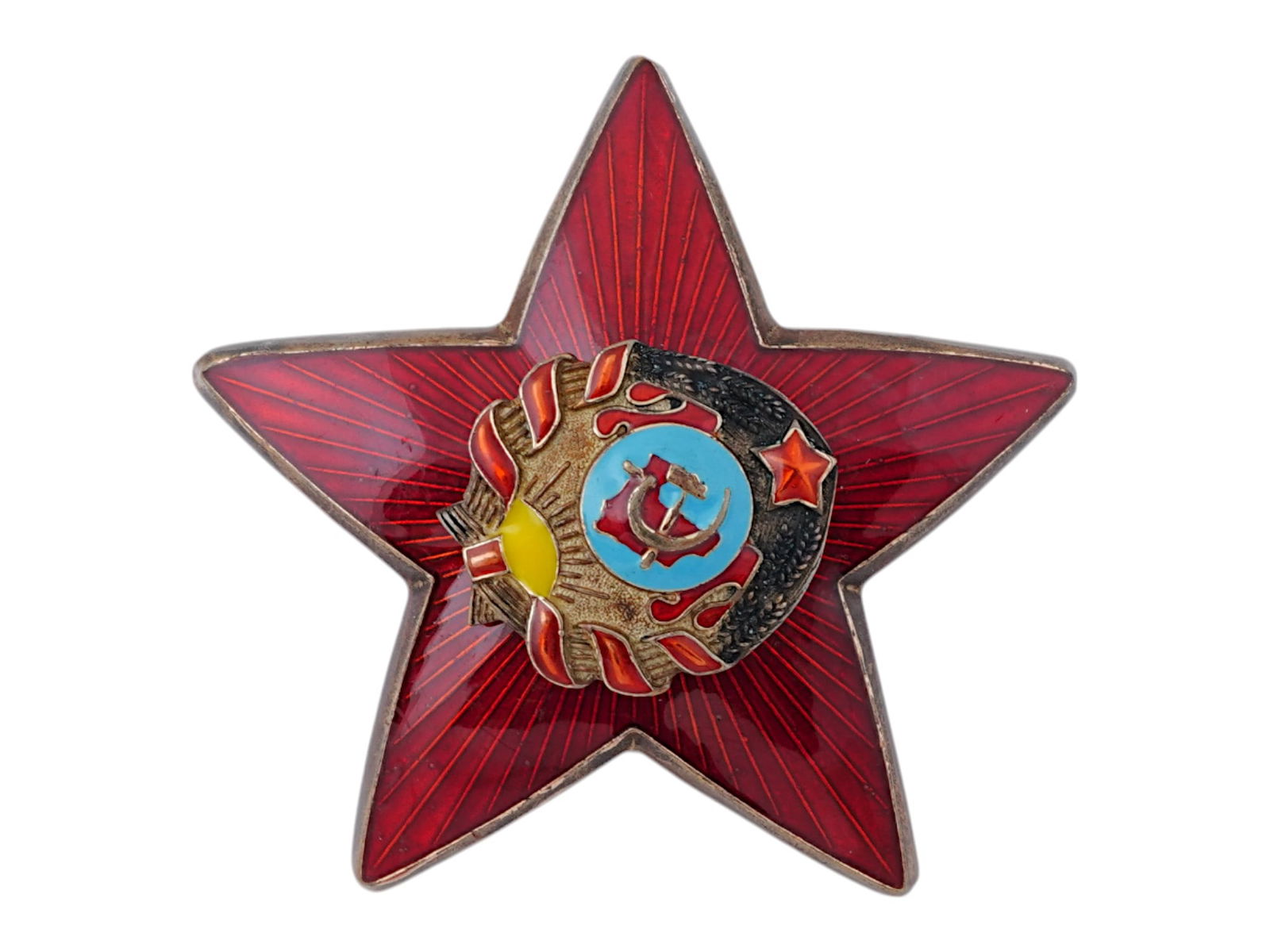 RUSSIAN SOVIET RED ENAMEL COCKADE POLICE CAP BADGE: A Russian Soviet enamel cockade police cap badge. The badge is in the form of a red enamel star with diverging rays. In the middle is a sickle and hammer in a wreath of wheat tied with a red ribbon. W