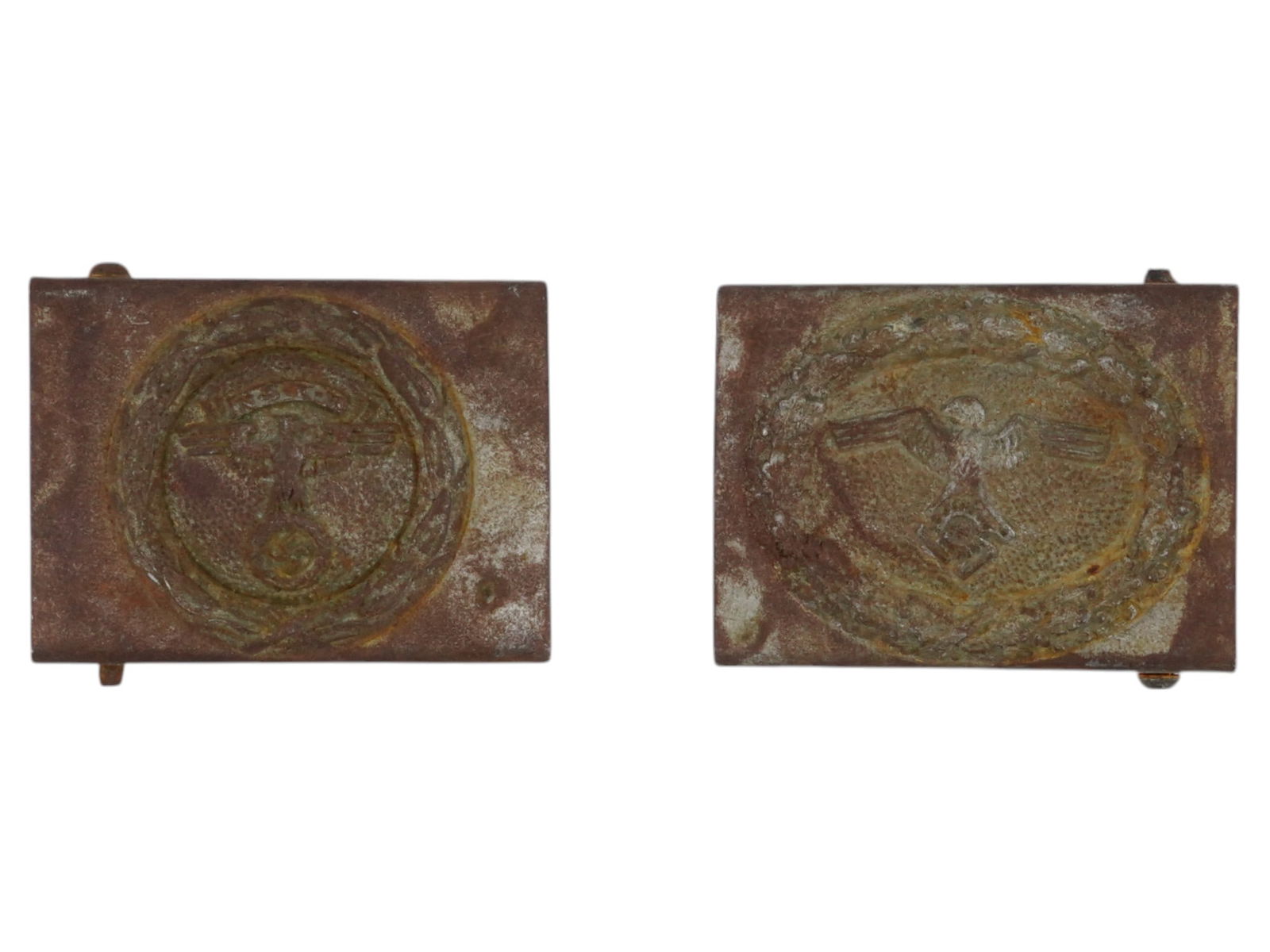 TWO WWII NAZI GERMAN TENO NSFK BELT BUCKLES: A lot of two WWII Nazi German TENO NSFK belt buckles. The first buckle features a central circular design of oak leaves with a Nazi eagle and a swastika with inscription NSFK above it. The second buck