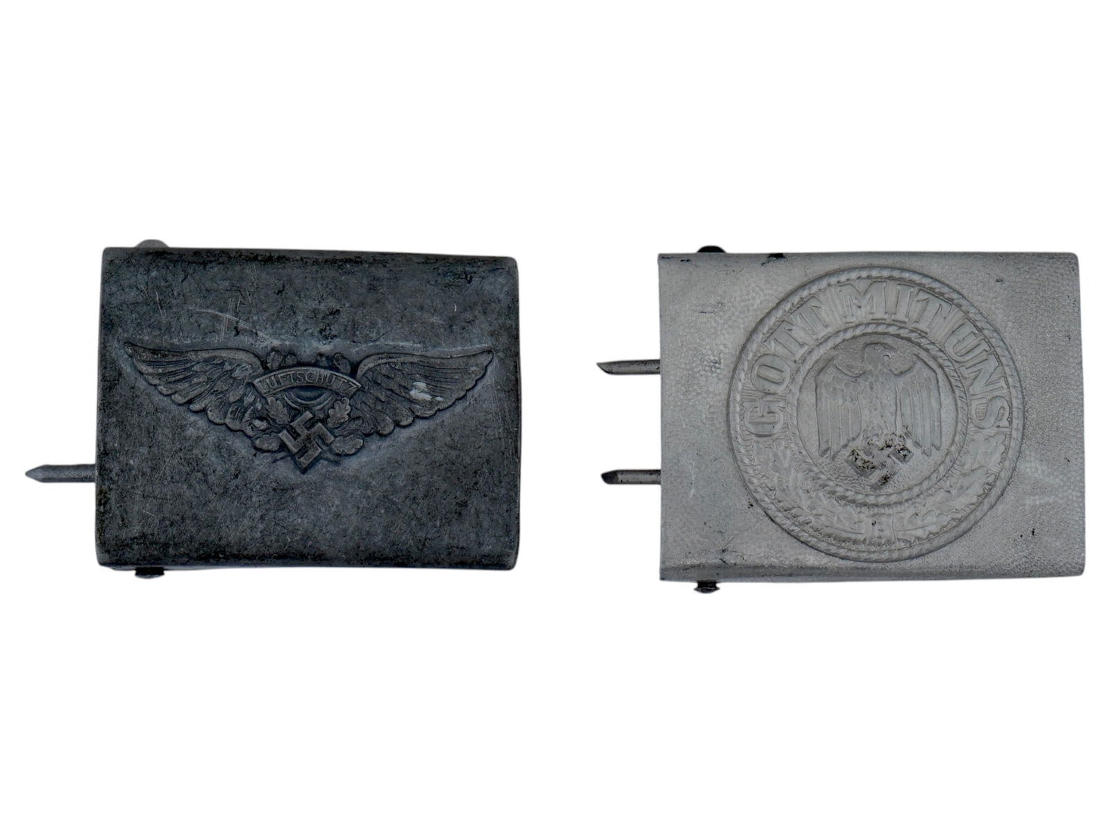 TWO WWII NAZI GERMAN WEHRMACHT BELT BUCKLES: A lot of two WWII Nazi German Wehrmacht belt buckles. The first is a Luftschutz buckle features wings with oak leaves and a swastika with the inscription Luftschutz above it. The second buckle feature