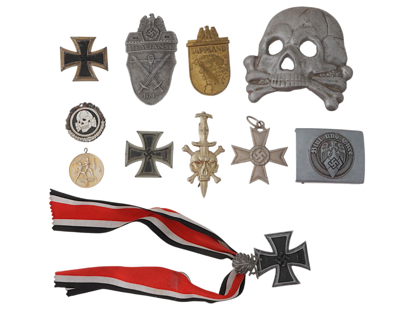 GROUP OF GERMAN WWII TYPE MEDALS AND BADGES: A group of German WWII type military pieces. A total of 10 items. The lot includes a Demyansk Shield, a Lapland Shield, a Czech Annexation Medal, a Totenkopf skull pin, four German Iron Crosses, one w