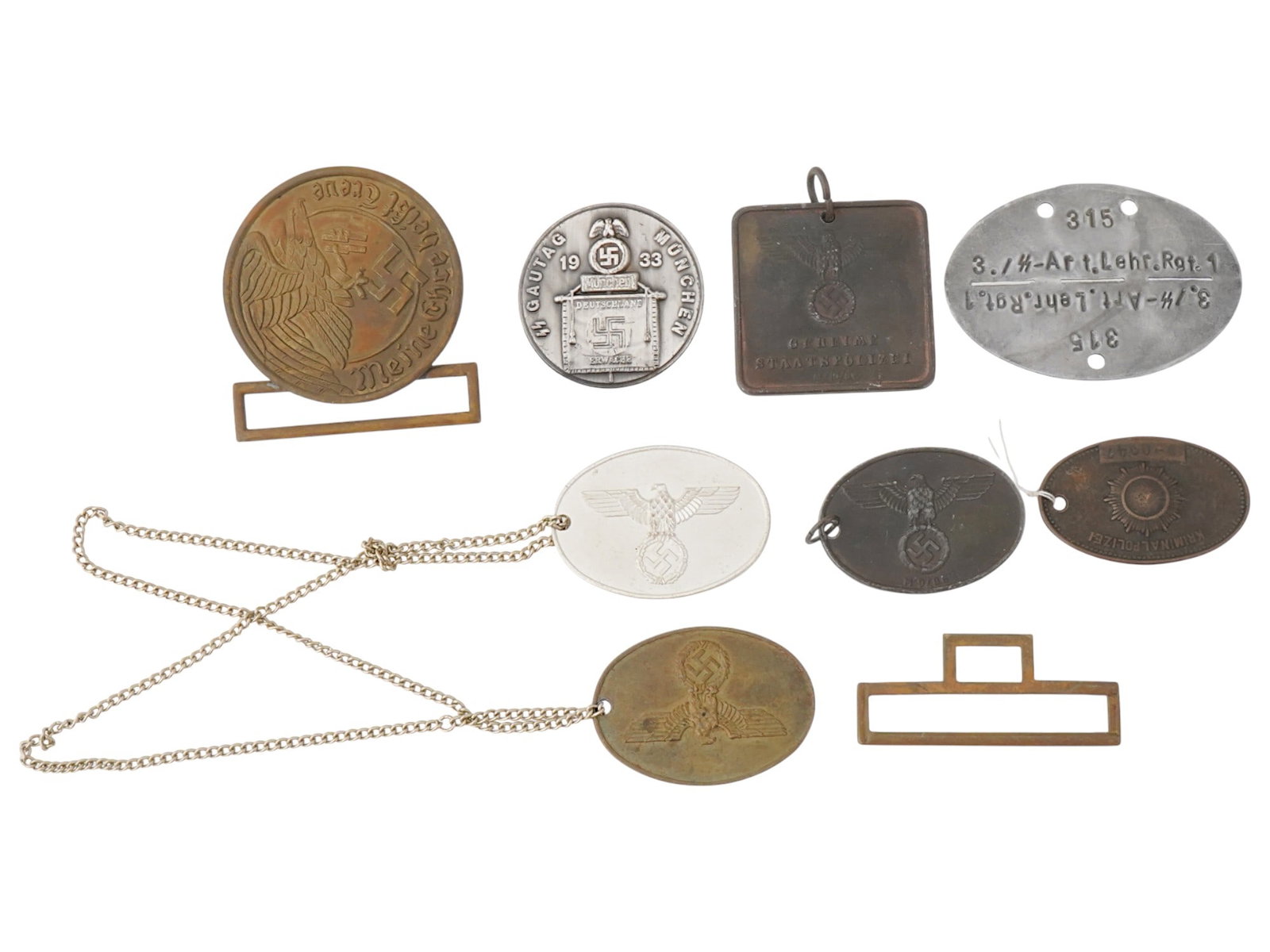 WORLD WAR II NAZI GERMAN MILITARIA AND POLICE ARTIFACTS: A collection of World War II Nazi German militaria and police artifacts, including a Waffen-SS officers Walther belt buckle, a Gau Tag Munchen 1933 badge, Gestapo identification tags. Also included ar