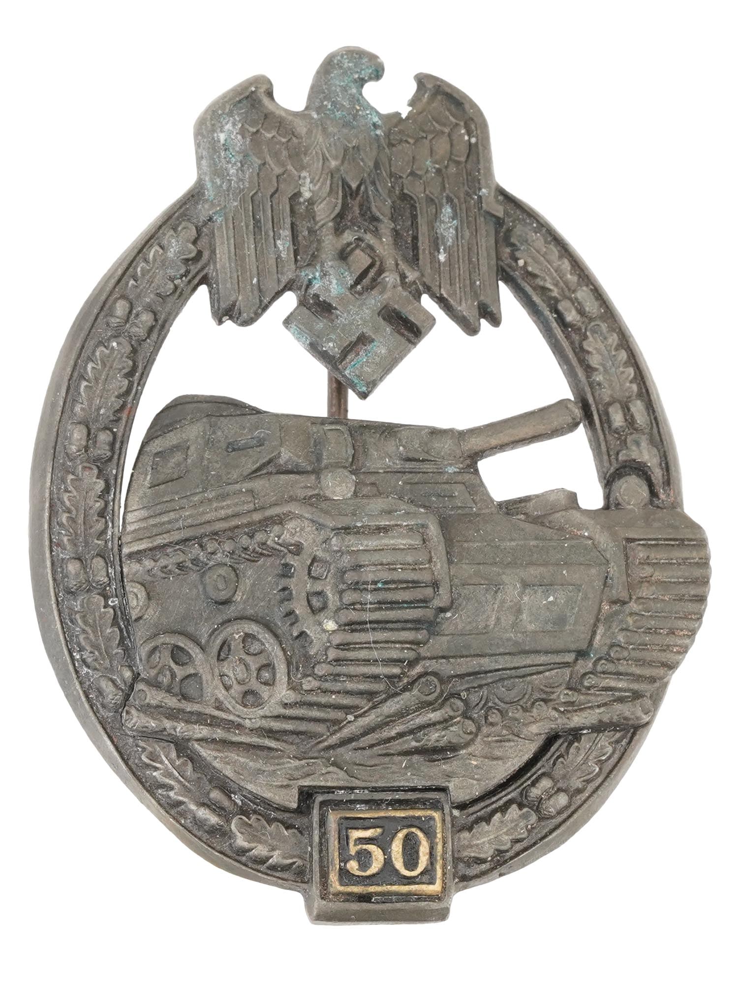 WWII NAZI GERMAN THIRD REICH ARMY TANK ASSAULT BADGE: A WWII Nazi German Third Reich Army Tank Assault badge for 50 assaults. The badge has an oval shape and is a three quarter front image of a Panzer IV tank, surrounded by an oak wreath and topped with
