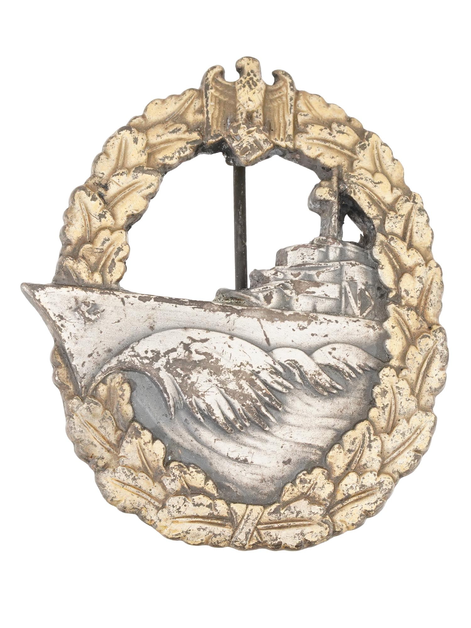 WWII NAZI GERMAN KRIEGSMARINE DESTROYER WAR BADGE: A WWII Nazi German Kriegsmarine destroyer war badge, featuring an outer oak leaf laurel wreath encircling the design, with the German national emblem, an eagle clutching a swastika, at the apex. The c