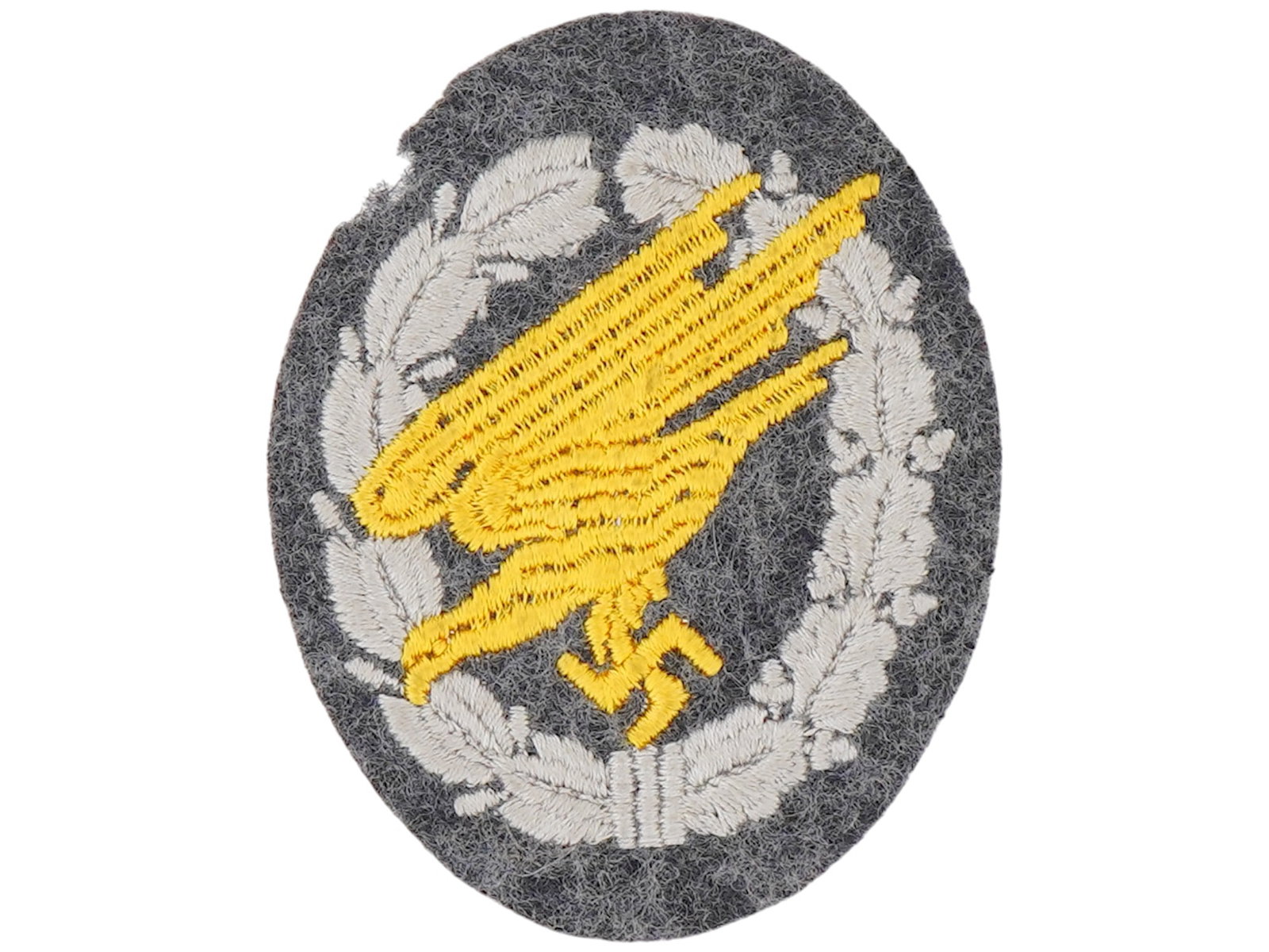 WWII GERMAN LUFTWAFFE PARATROOPER EMBROIDERED BADGE: A WWII German military Luftwaffe Paratrooper Embroidered Cloth Badge. The Parachutist Badge was a badge awarded to qualified parachutists of the Wehrmacht and the Waffen SS of Nazi Germany. The badge