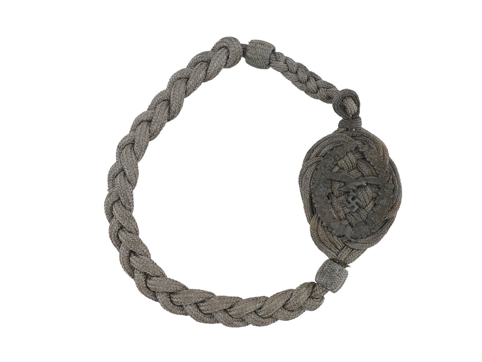 GERMAN WWII SCHUTZENSCHNUR LUFTWAFFE MARKSMAN CORD: A German WWII ceremonial Schutzenschnur, Luftwaffe marksman cord for excellent shooting. The tightly woven cord of silver tone with a badge modeled in the shape of a wreath of oak leaves, in the cente